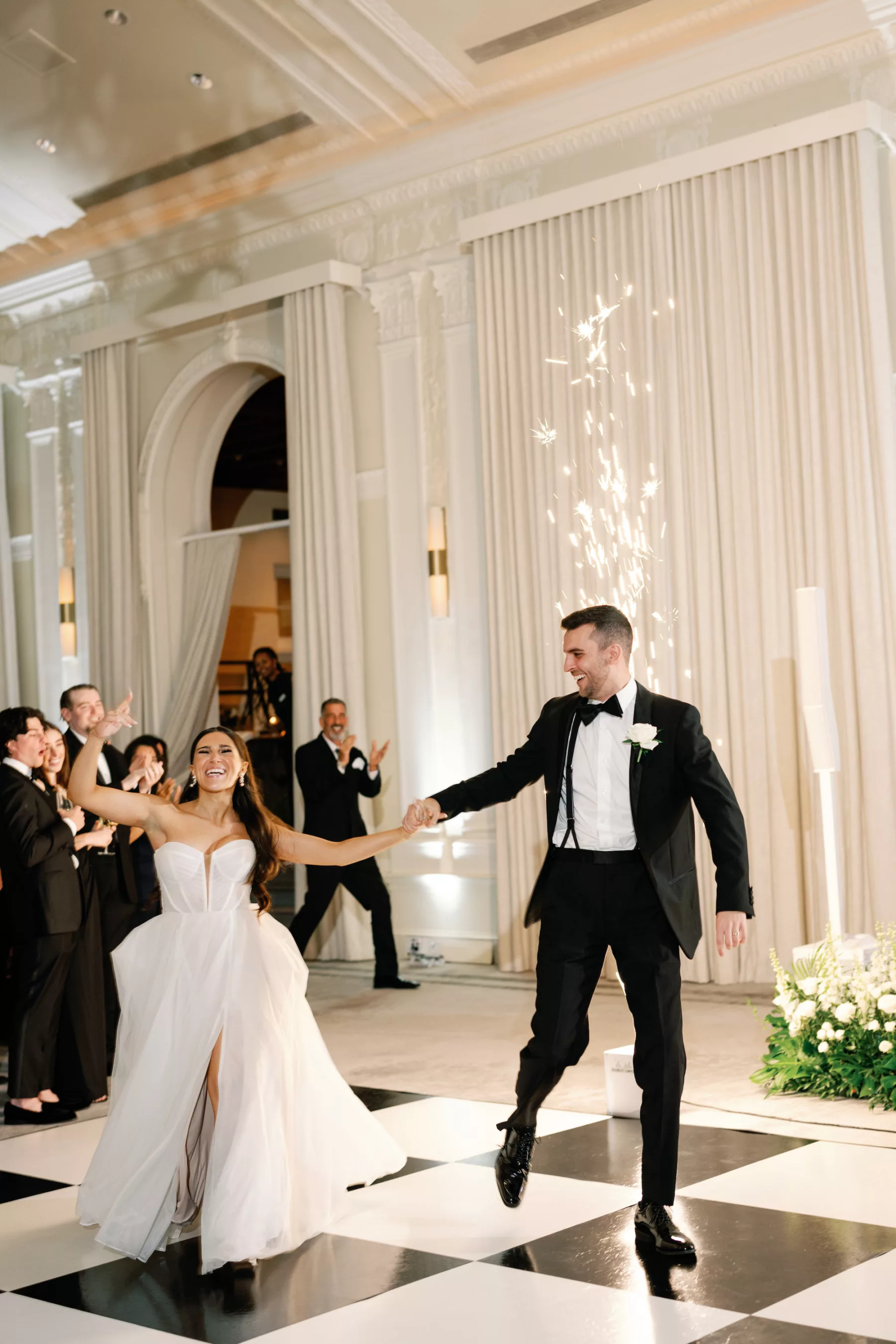 Bride and Groom Wedding Reception Ballroom Grand Entrance with Cold Spark Machines | Black and White Checkered Dance Floor Ideas | Tampa Bay Content Creator Behind The Vows | St Pete Event Planner Coastal Coordinating | DJ Graingertainment | Photographer Dewitt for Love Photography