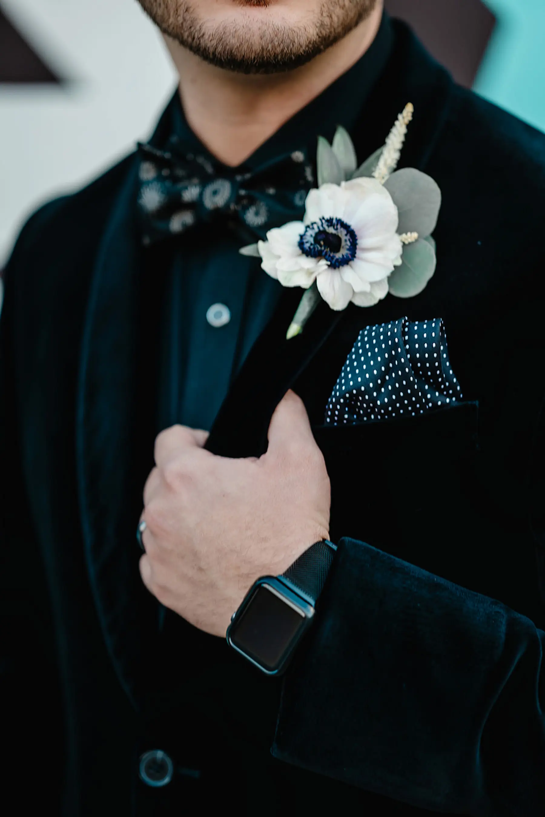 White Anemone and Greenery Groom Boutonniere Ideas | Black Velvet Jacket with Polka Dot Pocket Square Wedding Attire Inspiration