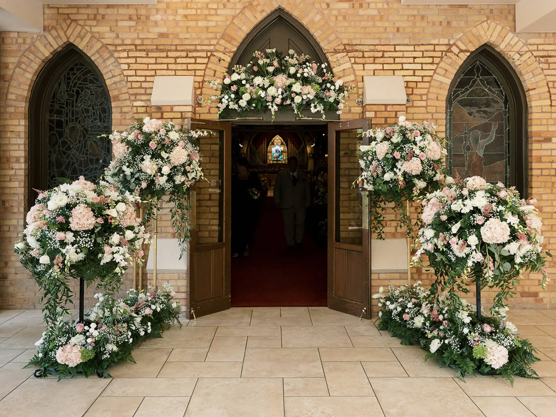 Whimsical Church Wedding Ceremony Entrance Decor Ideas | Pink Roses, White Hydrangeas, Baby's Breath, Fern, and Greenery Flower Arrangements | Cathedral Church of St. Peter St Pete