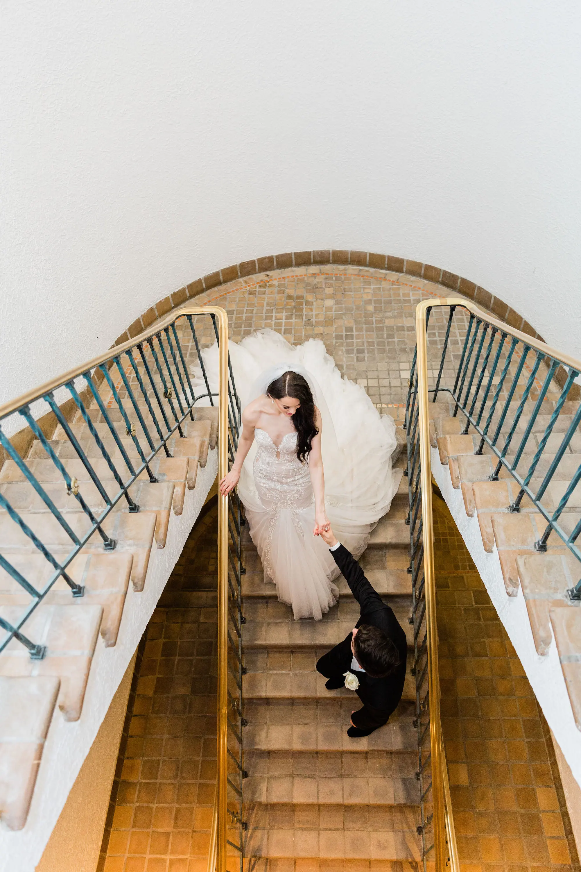 Bride and Groom Portrait of Walking Down Grand Staircase | Elegant Strapless Trumpet Gown Inspiration | Gown With Beading and Lace Appliqué Ideas | Dress by Ines Di Santo Inspiration | Natural Hair in Loose Waves Ideas | Soft Flowing Inspiration | St Pete Photographer K&K Photography | The Vinoy