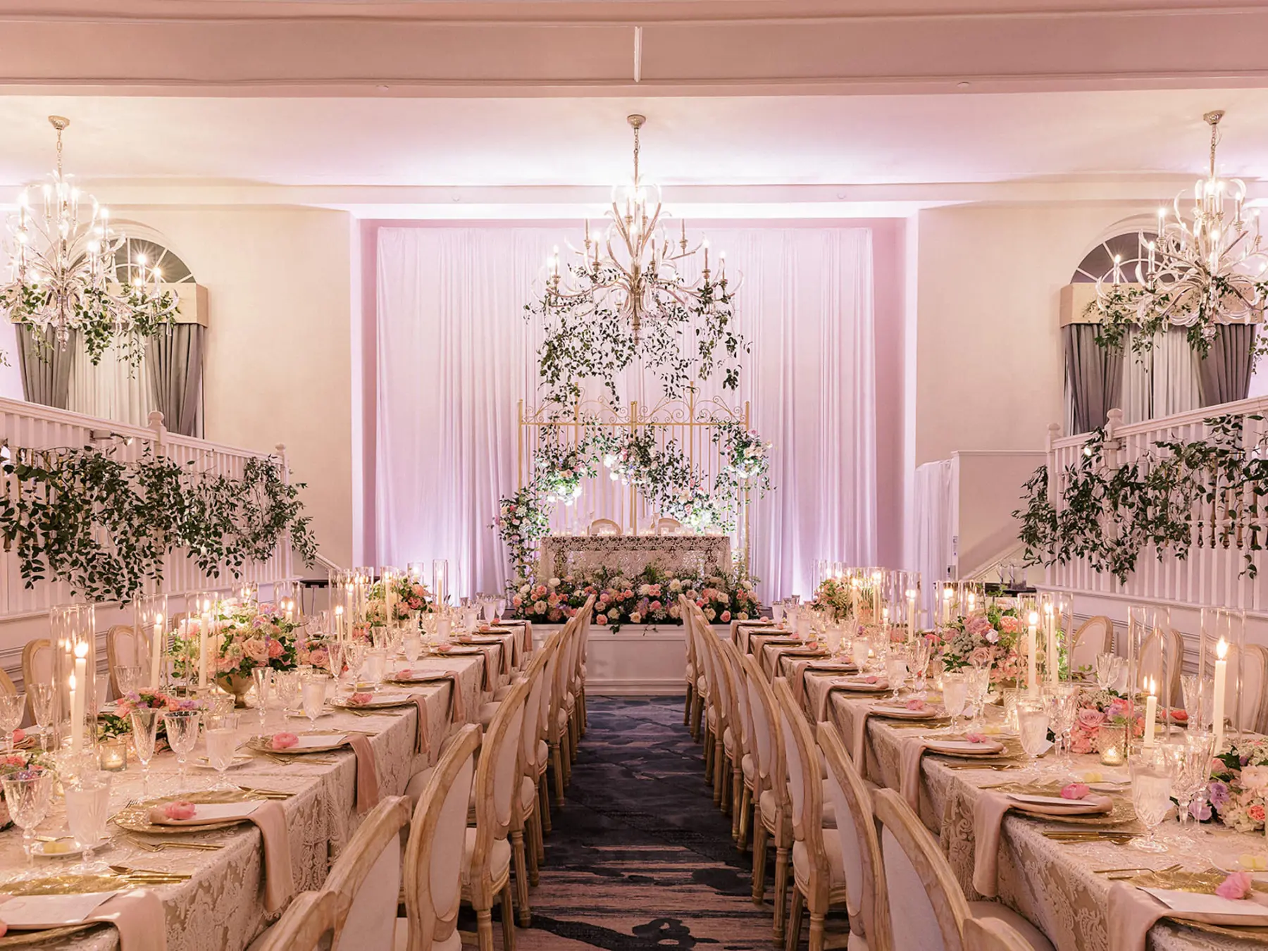 Whimsical Bridgerton Garden Ballroom Wedding Reception Inspiration | Long Feasting Tables | White Drapery Backdrop | Greenery Garland Decor Ideas | Tampa Bay Event Venue Don CeSar | St Pete Planner Unique Weddings and Events | A Chair Affair | Kate Ryan Event Rentals | Tampa Bay Staging and Events