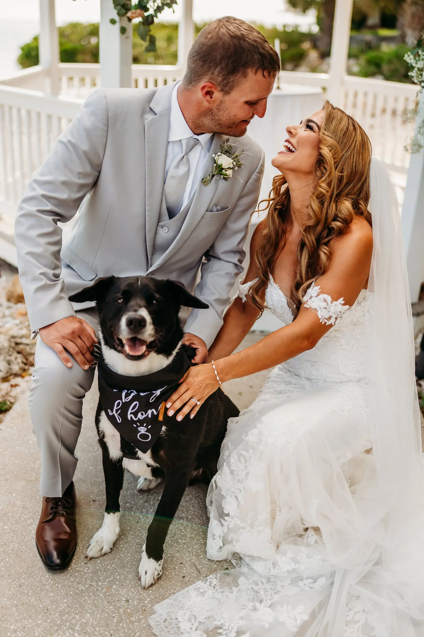 Bride and Groom with Dog Wedding Ceremony Ring Bearer Inspiration | Groom Gray Suits and Gray Ties Ideas | Fitted Casablanca Bridal Wedding Gown with Strapless Sweetheart Neckline and Floral Lace Appliques with Sequined Tulle Layer with Off the Shoulder Floral Lace Straps Ideas | Soft Beach Curls Wedding Hair Ideas | Tampa Bay Wedding Hair and Makeup Artist Adore Bridal Hair and Makeup | Tampa Bay Photographer Sabrina Autumn Photography