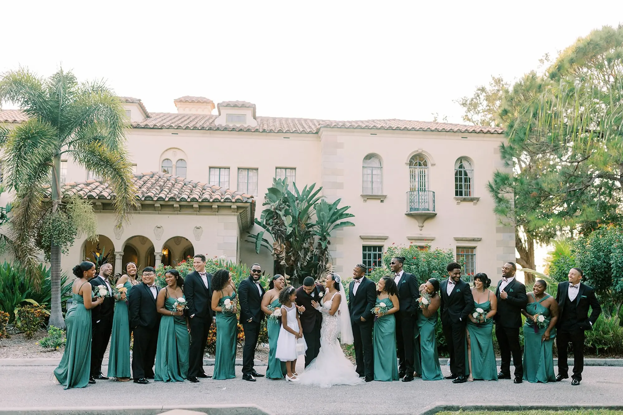 Bride and Groom with Bridal Party Wedding Portrait | Mismatched Emerald Green Bridesmaid Dresses Inspiration | Groomsmen in Black Tuxedos Wedding Attire Ideas | Tampa Bay Event Venue Powel Crosley Estate