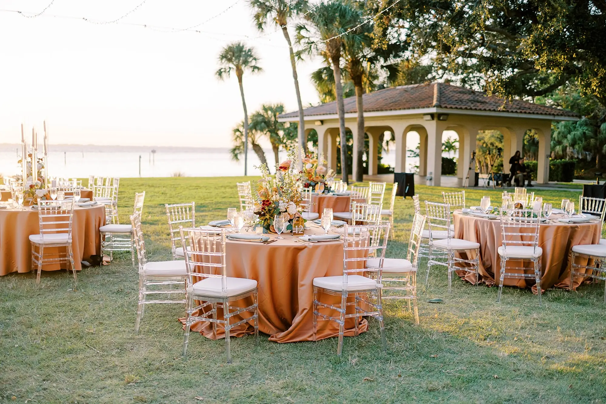 Romantic Neutral Outdoor Fall Wedding Reception Decor Ideas | Clear Chiavari Chairs, Peach Tablecloths | Sarasota Event Venue Powel Crosley Estate