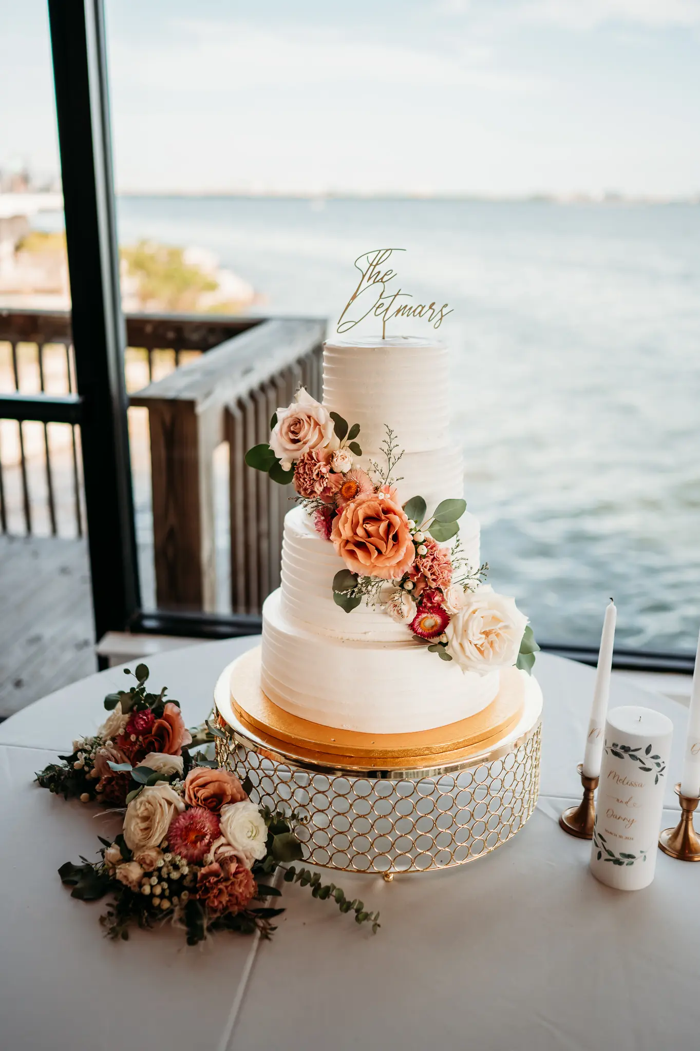 Four Tiered Simple Wedding Cake with Cascade of White, Blush, Light Pink and Coral Floral Decor Inspiration | Gold Taper Candle Vases and Accents Wedding Reception Decor Ideas | Waterfront Tampa Bay Wedding Venue Inspiration