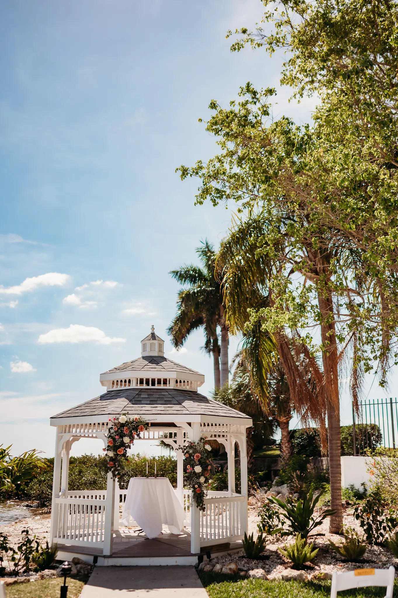 Waterfront Wedding Ceremony Venue Inspiration of White Gazebo with Eucalyptus and Soft White and Blush Florals | Tampa Bay Photographer Sabrina Autumn Photography | Tampa Venue Rusty Pelican