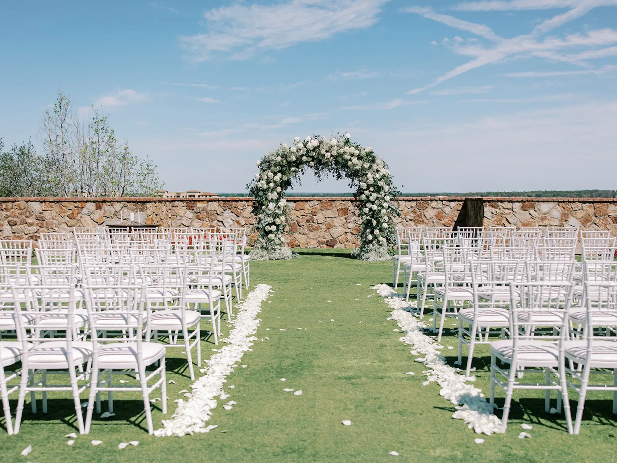 Luxurious Outdoor Italian Inspired Wedding Ceremony Decor Ideas | White Flower and Greenery Altar Inspiration | White Chiavari Chairs
