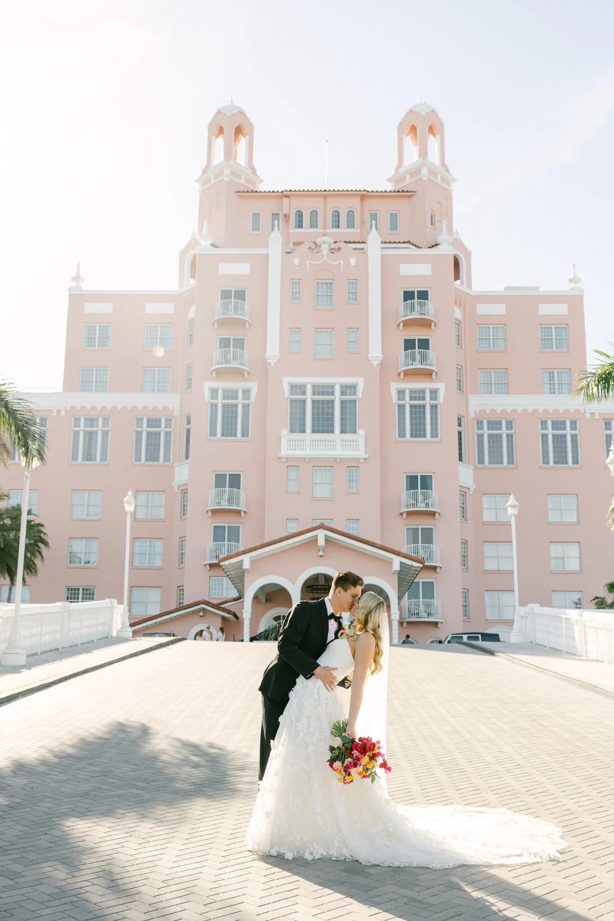Bride and Groom Kissing in front of Historic Pink Palace St Pete Beach Wedding Venue Don CeSar