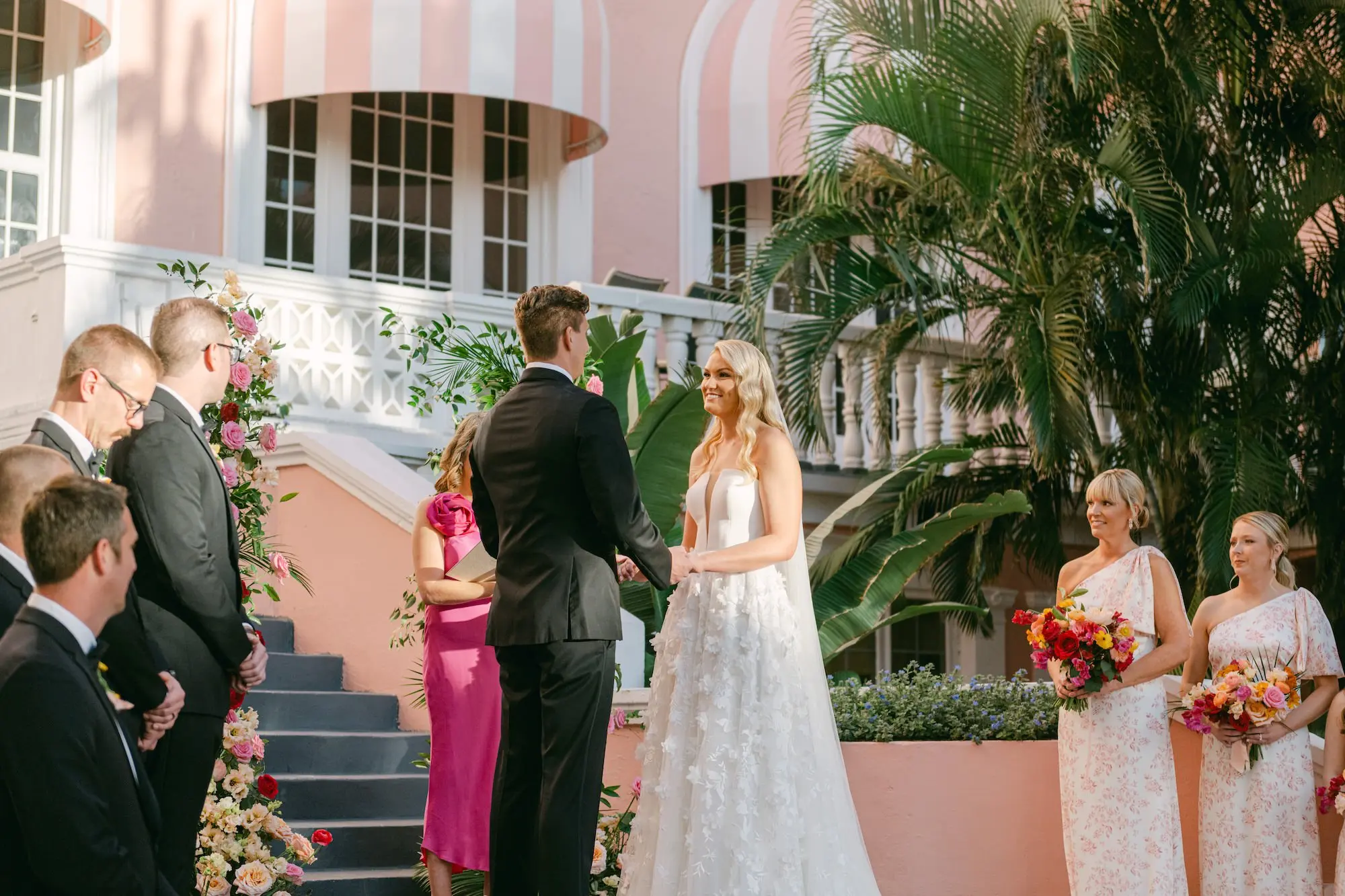 Bride and Groom Wedding Ceremony Vow Exchange Wedding | Vibrant Whimsical St Pete Beach Old Florida Wedding Ceremony Decor Inspiration | Pink, Red, Peach, Orange Floral Arrangement Wedding Ceremony Altar Decor Ideas | St Pete Event Venue The Don Cesar