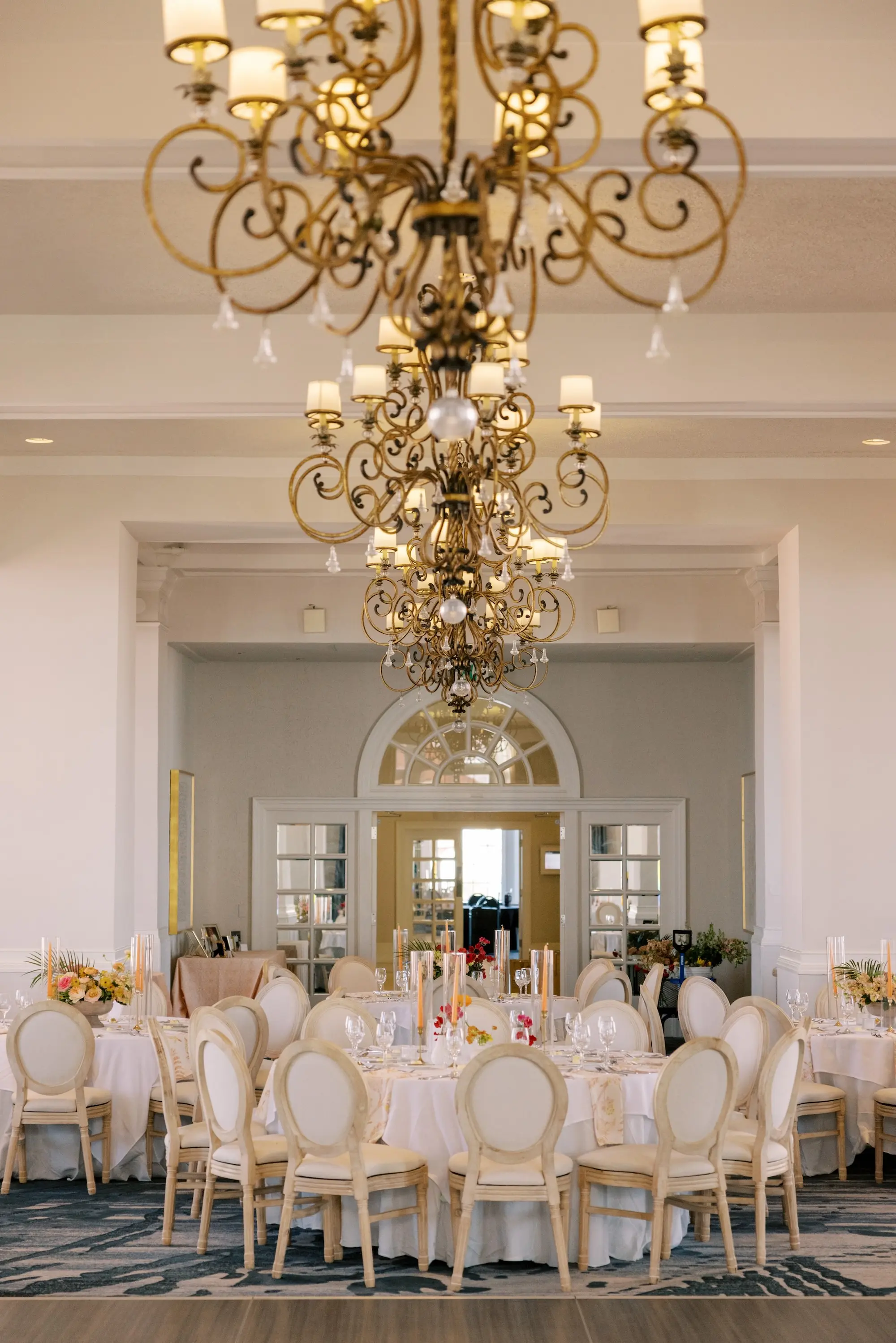 Luxurious Ballroom Wedding Reception | Modern Natural King Louis Chairs | Tall Citrus Orange Taper Candles in Glass Vases Table Decor Ideas | Tampa Bay Planner MDP Events | Venue The Don Cesar