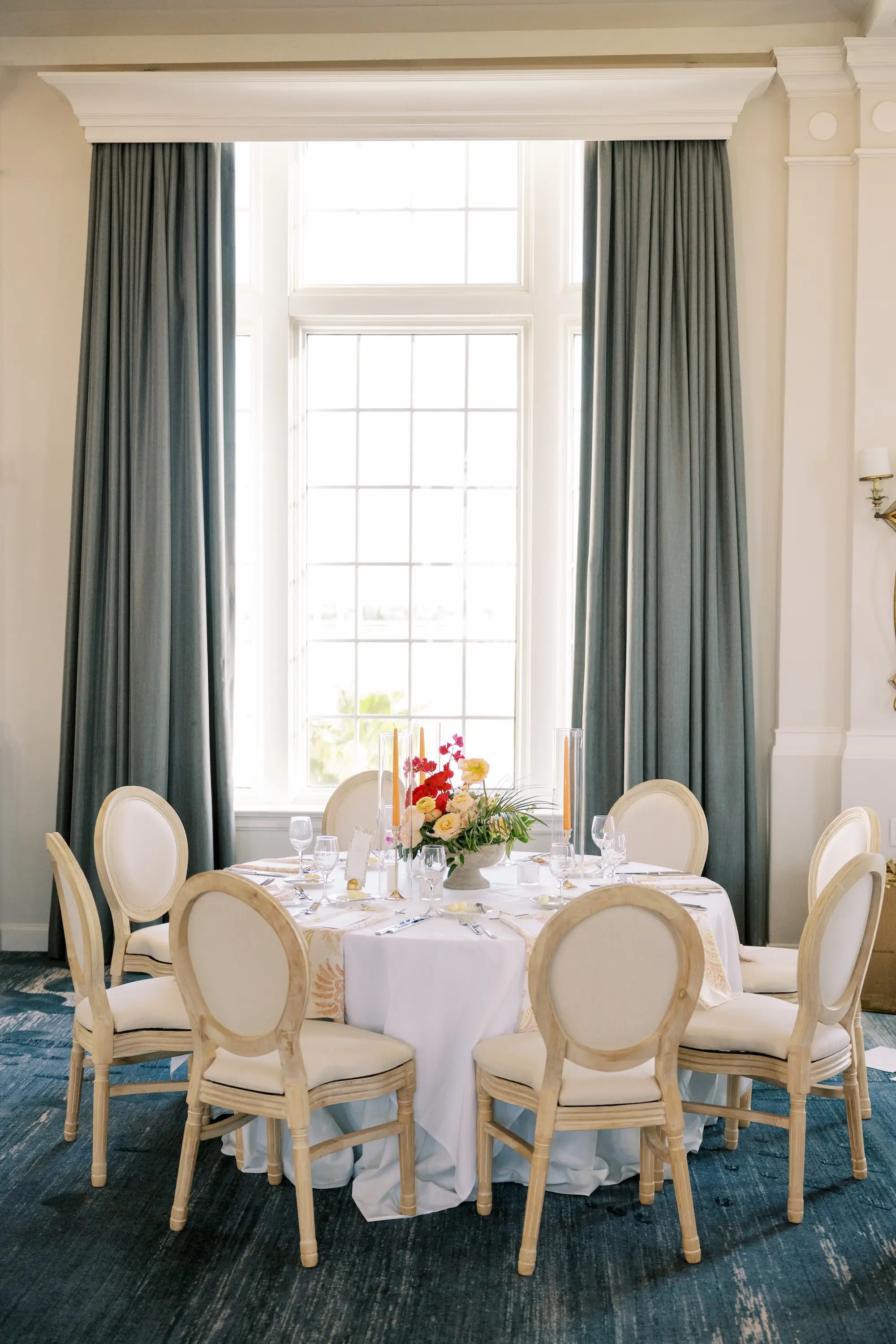 Luxurious Ballroom Wedding Reception | Modern Natural King Louis Chairs | Tall Citrus Orange Taper Candles in Glass Vases Table Decor Ideas | Tampa Bay Planner MDP Events | Venue The Don Cesar