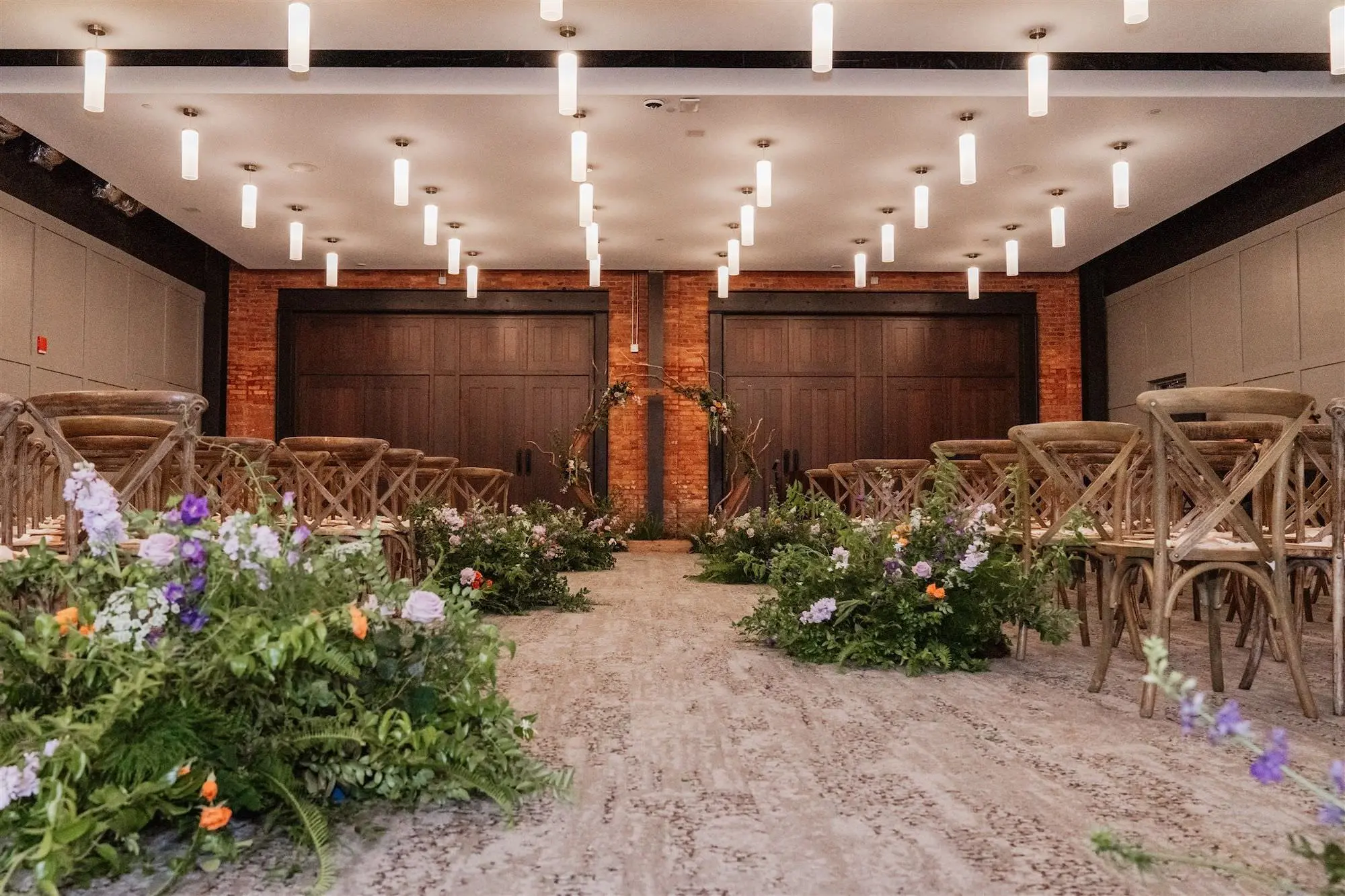 Whimsical Lord of the Rings Wedding Ceremony Decor Ideas | Purple and Orange Flowers and Greenery Ferns Aisle Arrangements Inspiration | Wooden Ceremony Chair Rentals A Chair Affair | Tampa Bay Event Venue Armature Works | Planner UNIQUE Weddings and Events