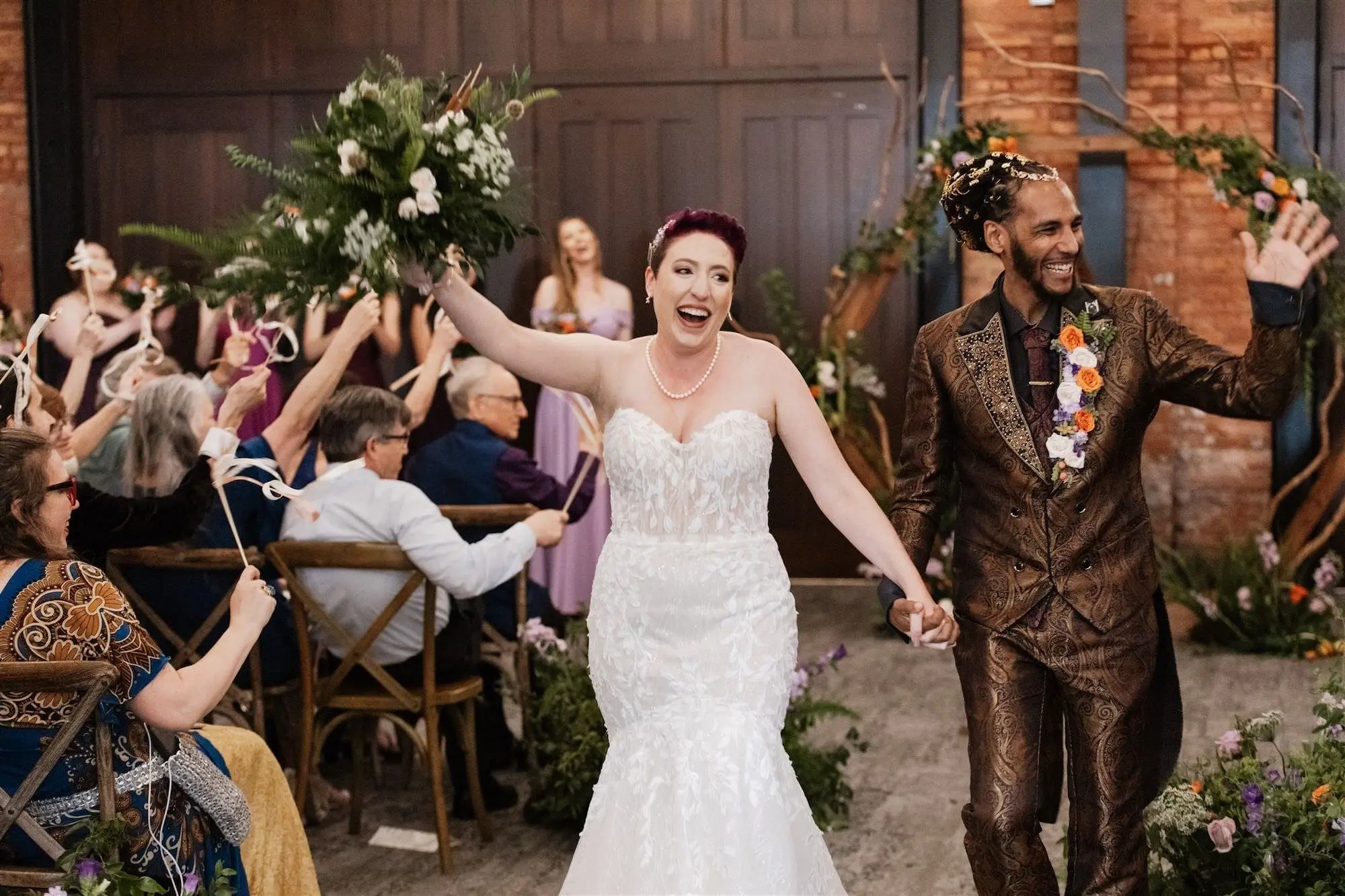Bride and Groom Just Married Wedding Portrait | Short Wedding Hair Inspiration | Whimsical Lord of the Rings Wedding Ceremony Decor Ideas | Purple and Orange Flowers and Greenery Ferns Aisle Arrangements Ideas | Wooden Ceremony Chair Rentals A Chair Affair | Tampa Bay Event Venue Armature Works | Planner UNIQUE Weddings and Events | Tampa Bay Hair and Makeup Artist Michele Renee The Studio