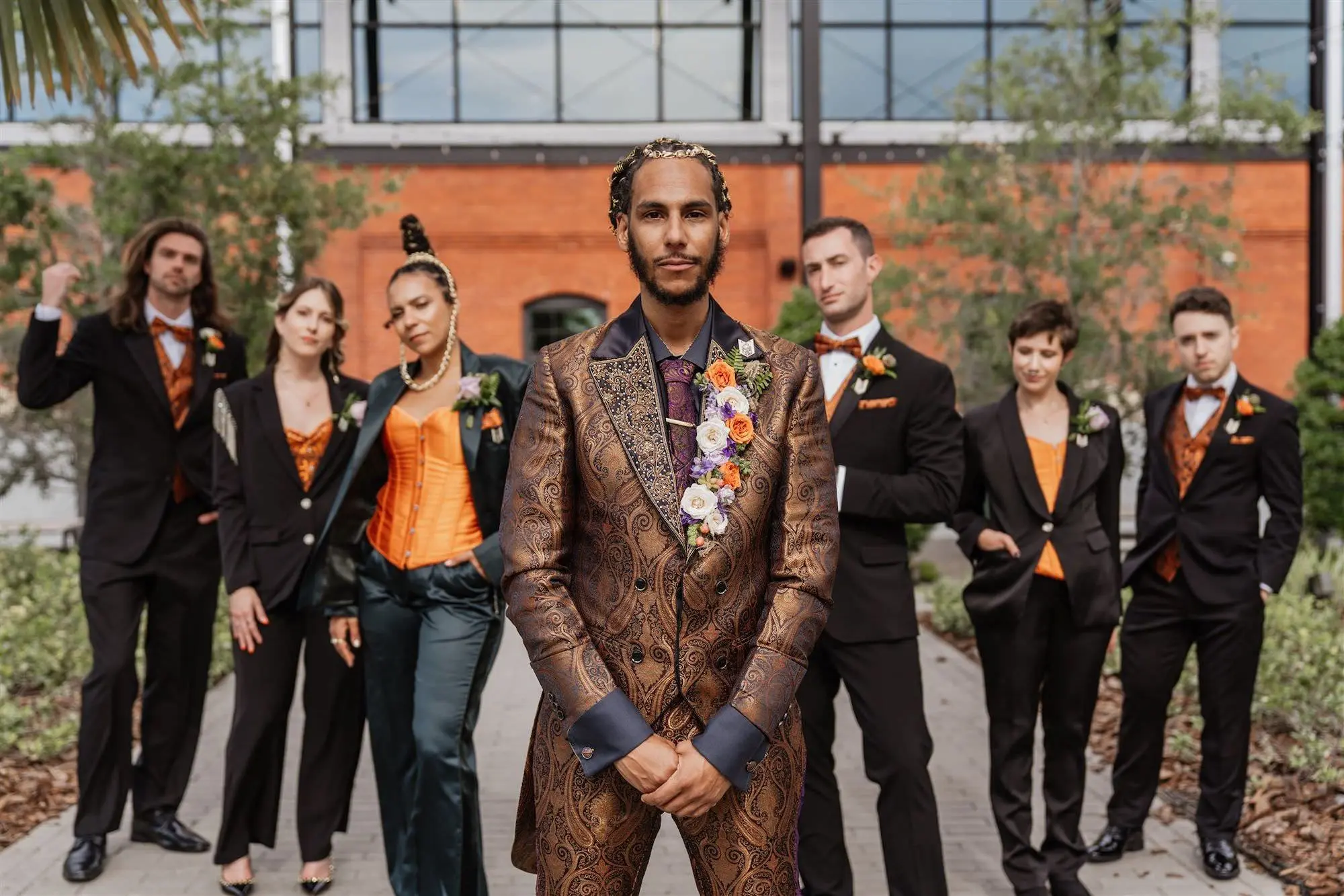 Gold and Black Paisley Patterned Groom's Suit Inspiration | Groomsmen in Black and Orange Wedding Attire Ideas | White, Orange, Purple Floral Lapel Boutonniere Inspiration
