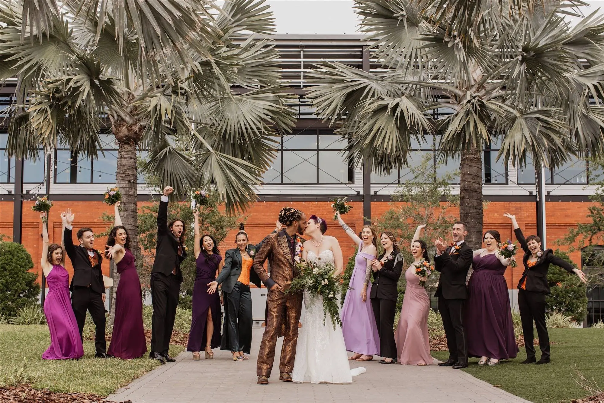 Whimsical Lord of the Rings Wedding Party Attire Ideas | Different Shades of Purple Bridesmaid Dress Inspiration | Black and Orange Groomsmen Suits Ideas | Elegant Fantasy Wedding Theme Inspiration