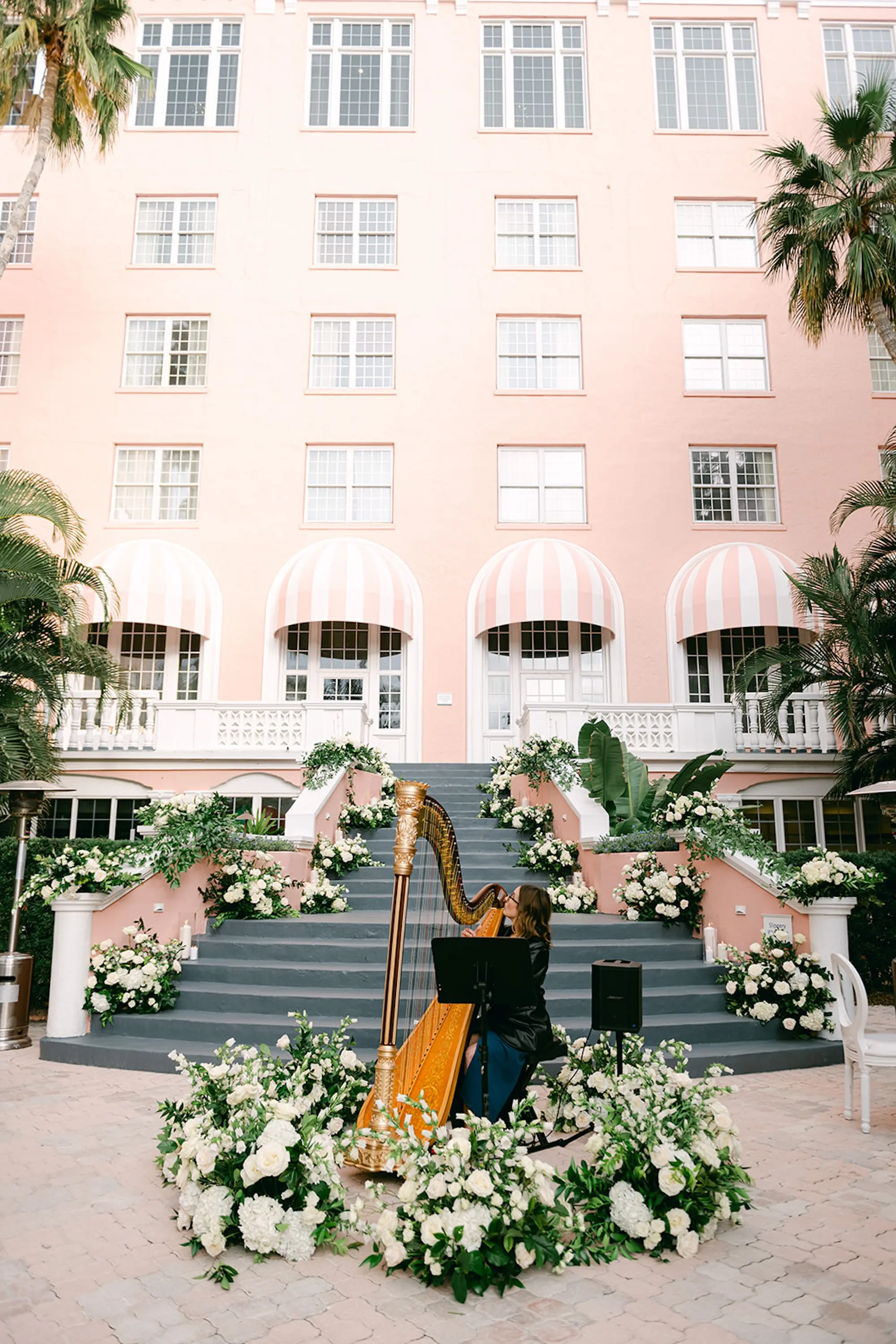 Romantic Wedding Ceremony Harpist Live Music Ideas | White Roses and Flowers in Lush Greenery Timeless Floral Decor Inspiration | St Petersburg Pink Palace Wedding Venue The Don CeSar