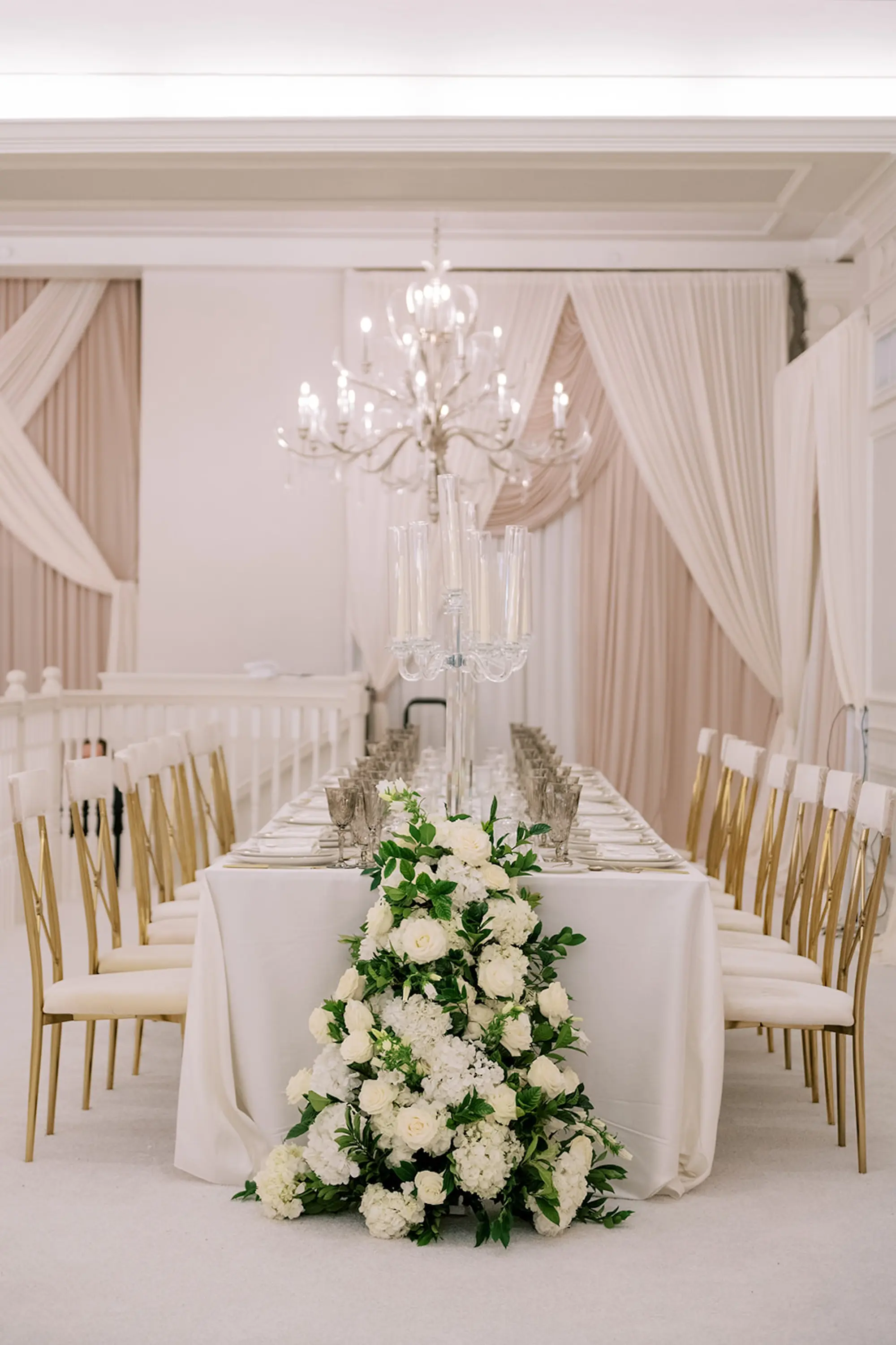 Luxurious Ivory and Gold Wedding Reception Long Feasting with White Linens and White and Gold Chairs Inspiration | White Roses and Florals with Greenery Flower Arrangement Centerpieces Table Decor Ideas | Tampa Bay Planner Parties A'La Carte | St Pete Beach Historic Hotel Resort Venue The Don CeSar