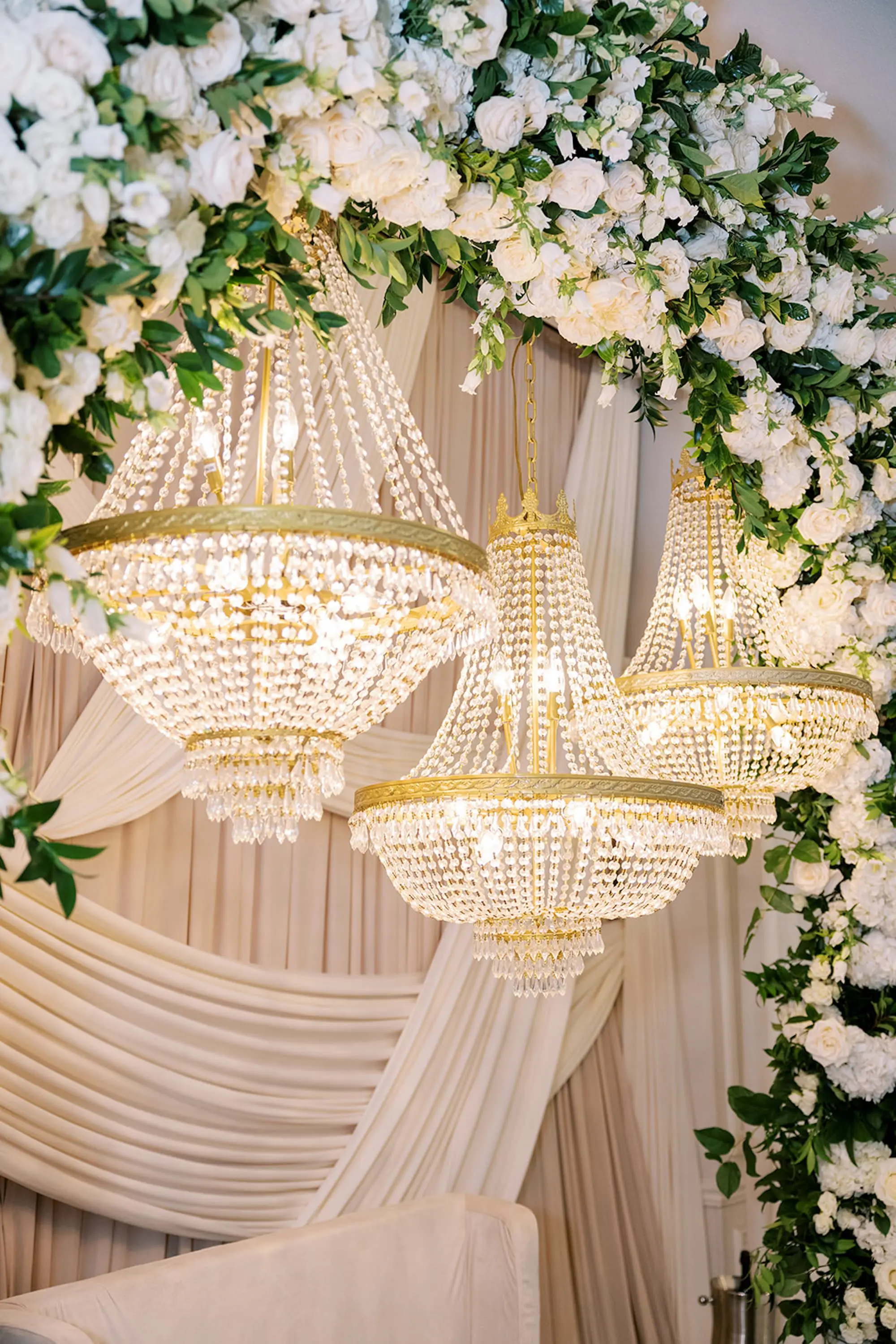 Crystal Chandelier Wedding Reception Table Decor Inspiration | Classic, Luxurious White Roses and Flowers in Lush Greenery Arch Floral Decor Centerpieces Ideas | St Pete Event Planner Parties A La Carte