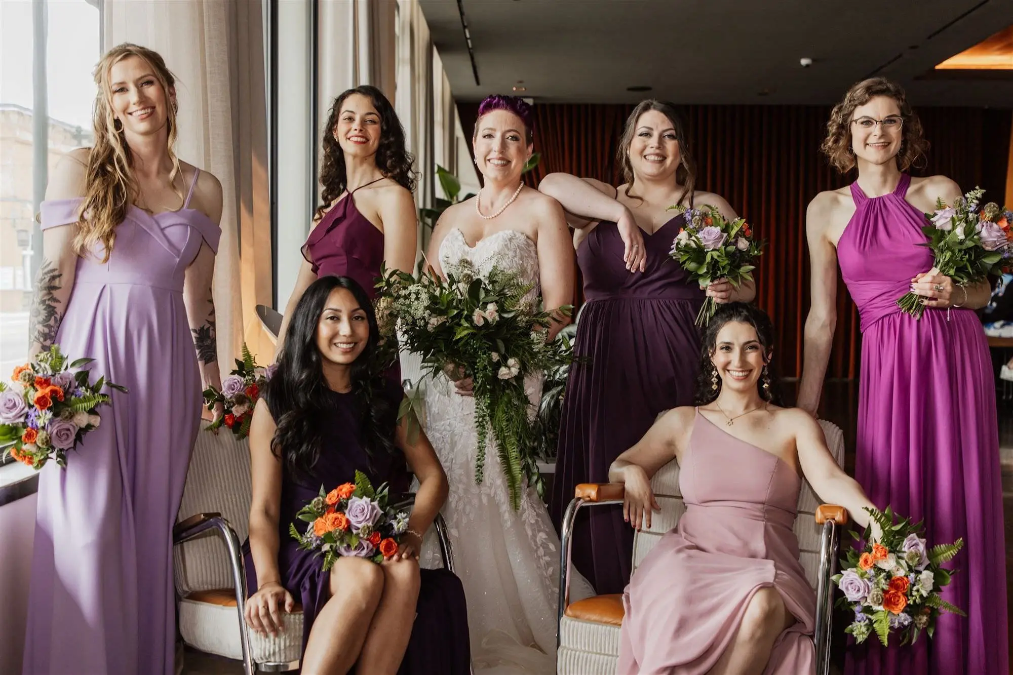 Mismatched Shades of Purple Bridesmaid Dress Ideas | Greenery Eucalyptus and Fern with White Florals Bridal Bouquet Inspiration | Pastel Purple and Orange Bridesmaid Bouquets with White Wisteria and Greenery Ideas | Tampa Bay Hair and Makeup Artist Michele Renee The Studio