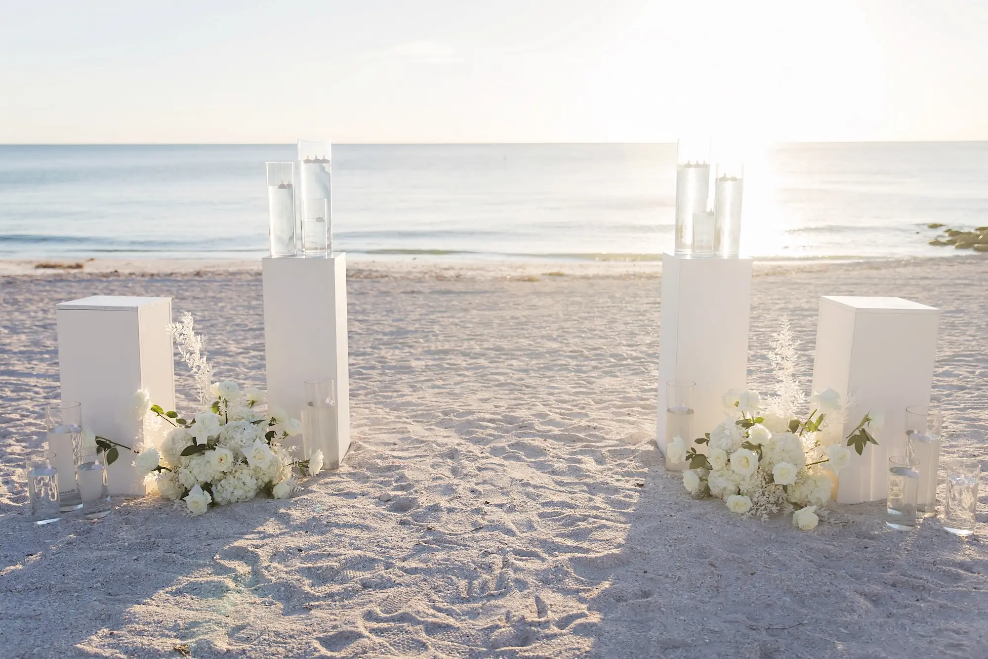 Romantic White Wedding Ceremony Altar Decor Ideas | White Flowers and Floating Candles on White Pillar | Sarasota Florist Beneva Flowers
