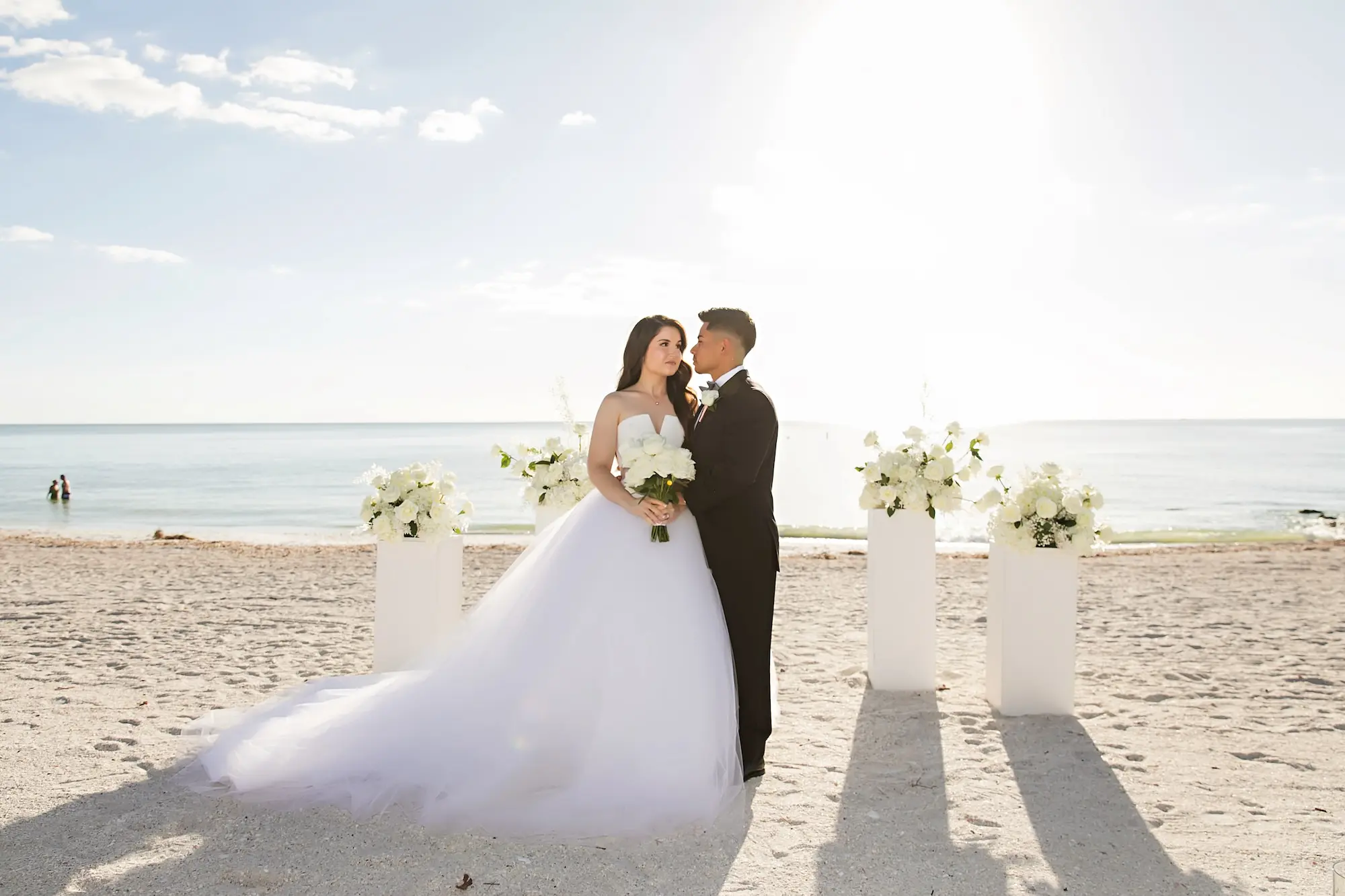 Romantic Florida Beach Wedding Ceremony Decor Ideas | White Roses on White Pillars | Sarasota Florist Beneva Flowers | Tampa Bay Photographer Limelight Photography | Event Venue Lido Beach Resort