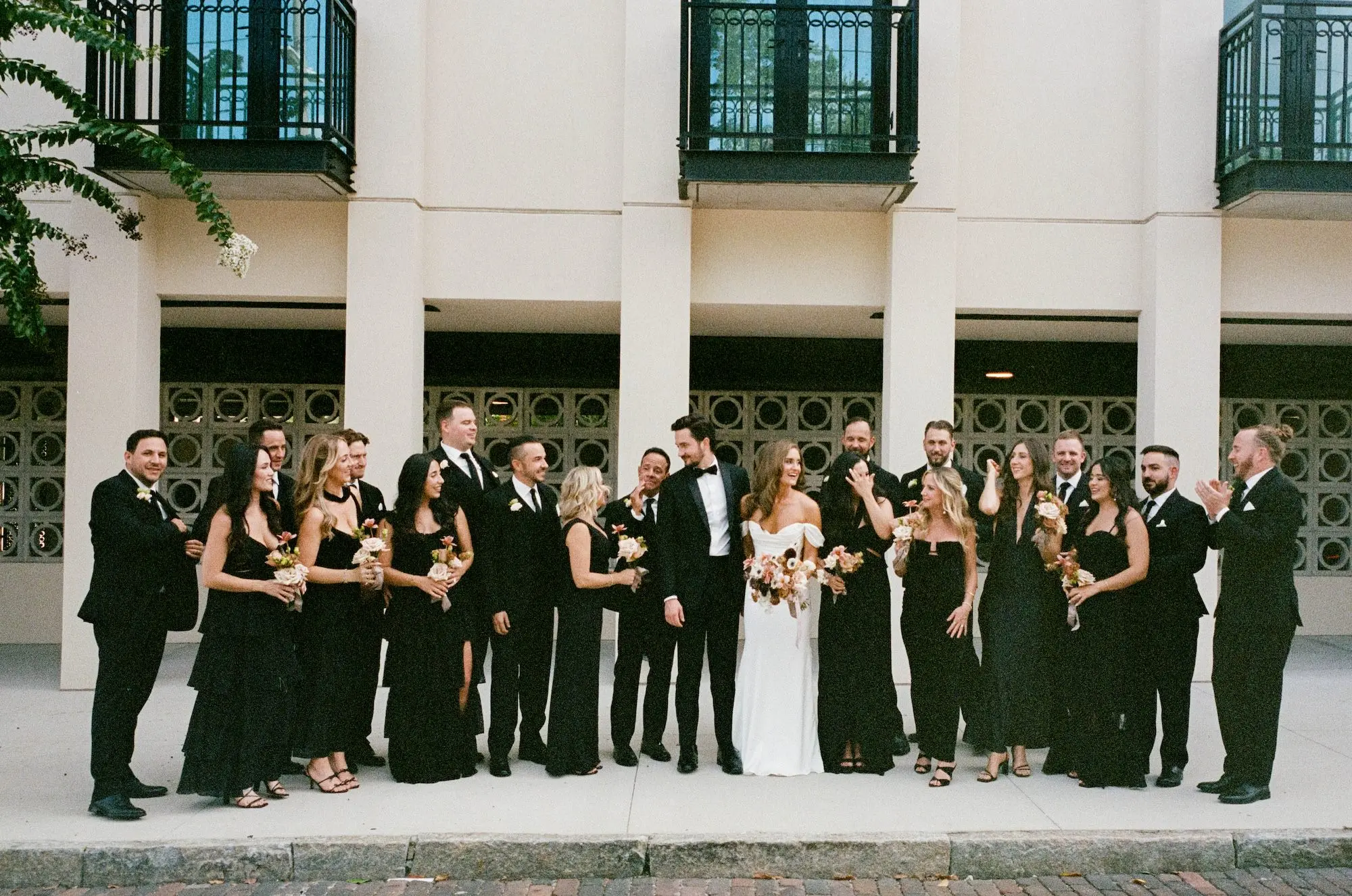 Timeless Modern Wedding Party Attire Inspiration | Bridesmaids in Mismatched Black Dresses | Groomsmen in Black Tuxedos