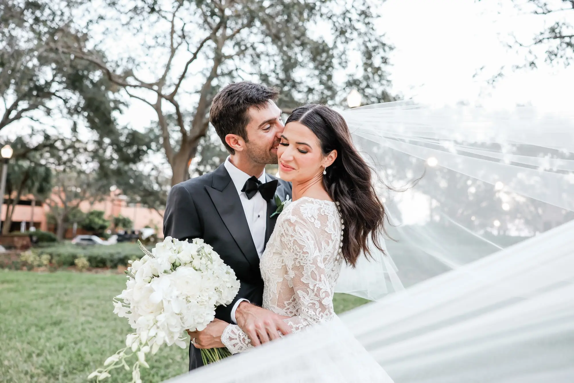 Bride and Groom Wedding Portrait in Classic Chiffon Cathedral Length Wedding Veil Inspiration | Traditional Monochromatic White Floral Bridal Bouquet Ideas | Tampa Bay Wedding Photographer Lifelong Photography Studio