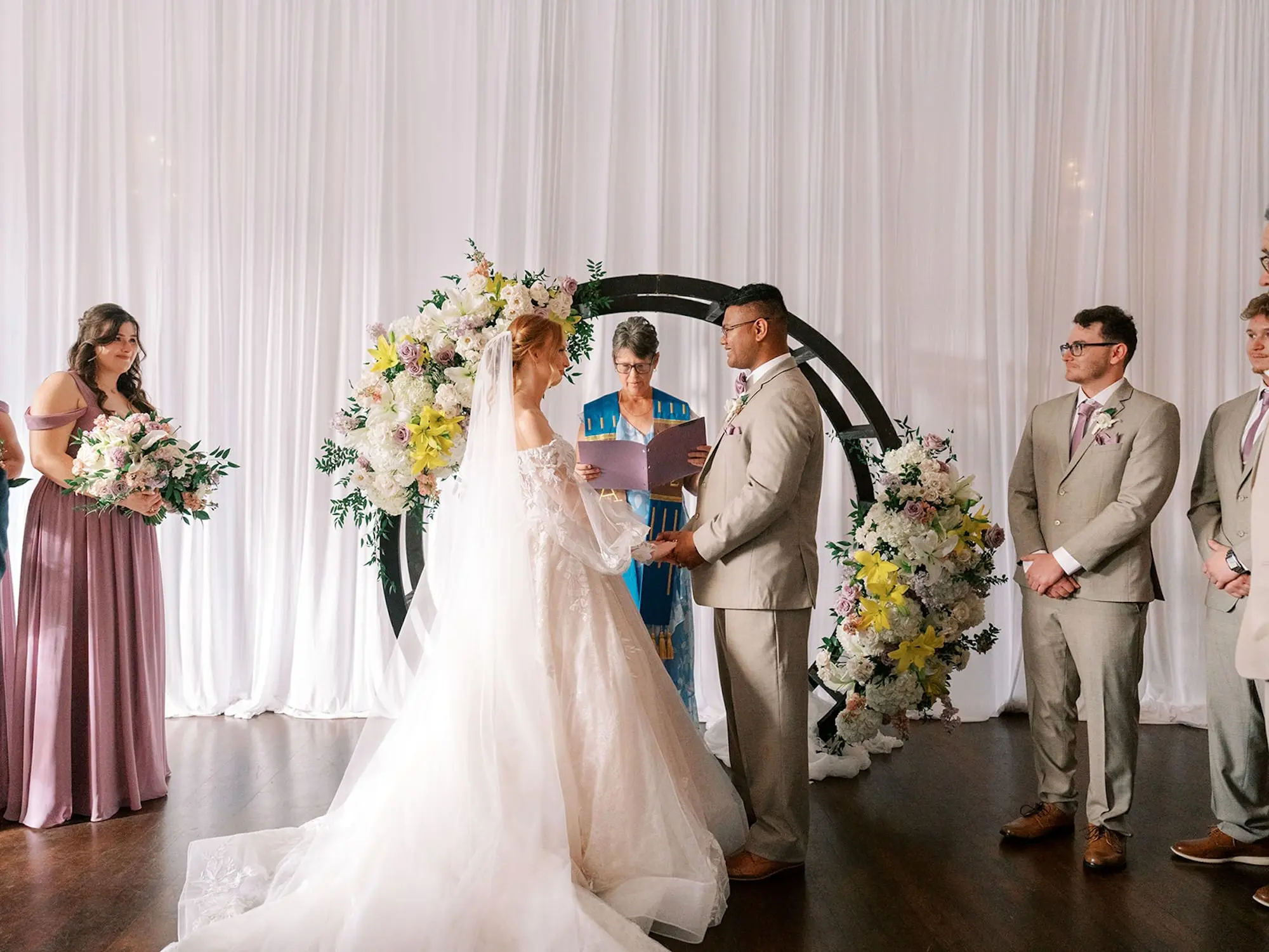 Bride and Groom Wedding Ceremony Vow Exchange Wedding | Black Circle Altar Backdrop Ideas | Cathedral Length Chiffon Veil Inspiration | Soft, Pastel Blush, Lavender, Yellow, White Floral Arrangements of Roses, Hydrangeas, Lilies Wedding Ceremony Altar Decor Ideas | South Tampa Photographer Eddy Almaguer Photography