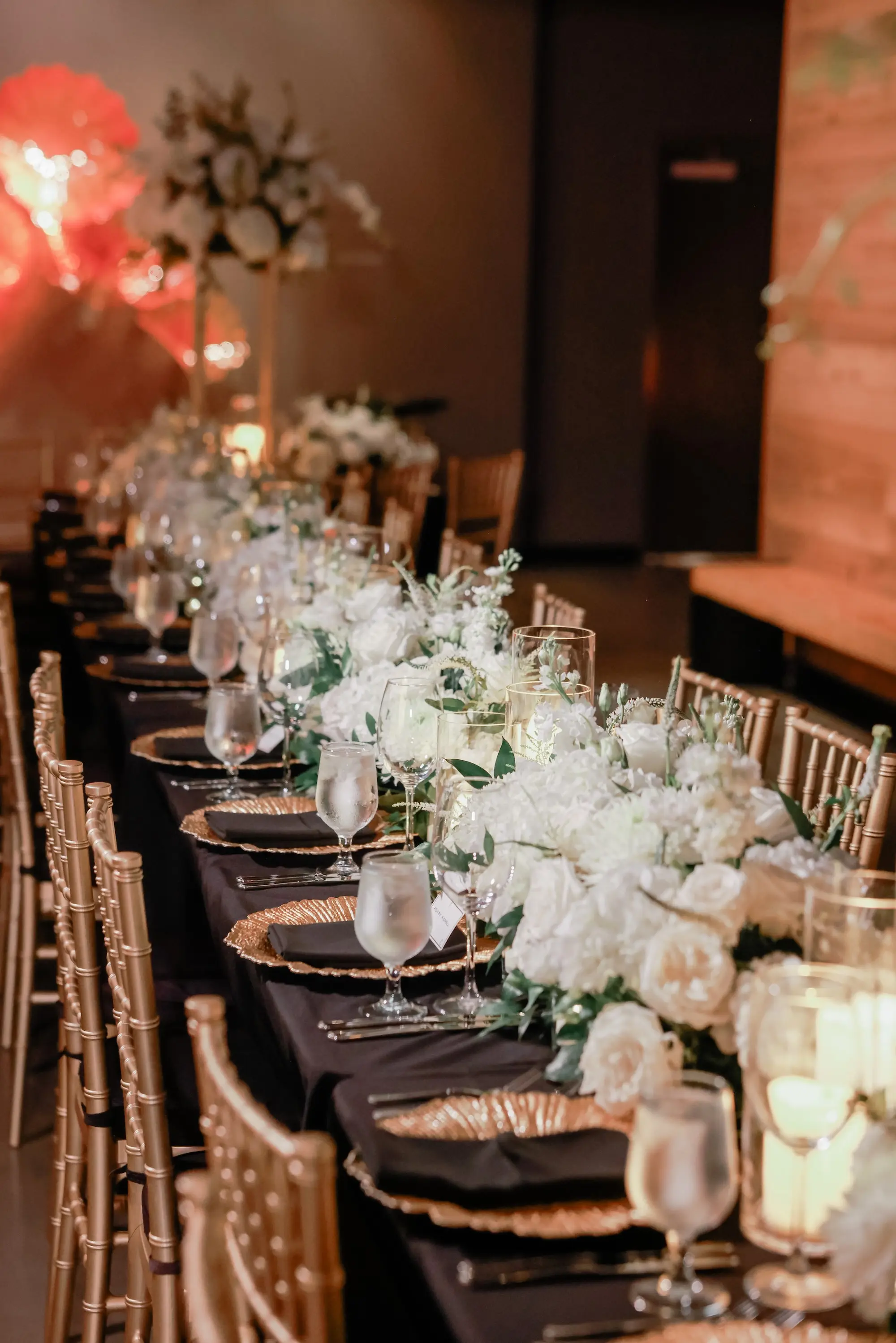 27Classic White Chic St Pete Museum Wedding Inspiration - “Best Of” 2025: Wedding Receptions Part 2 Intimate Elegant Chic Ballroom Wedding Reception | Gold Chiavari Chairs | Floral Garland with White Roses Flower Arrangement Ideas | Black Table Linens with Gold Chargers and Black Napkins Tablescape Decor Inspiration | St Pete Elite Events Catering | Venue The Chihuly Collection at the Morean Arts Center | Tampa Bay Planner Coastal Coordinating
