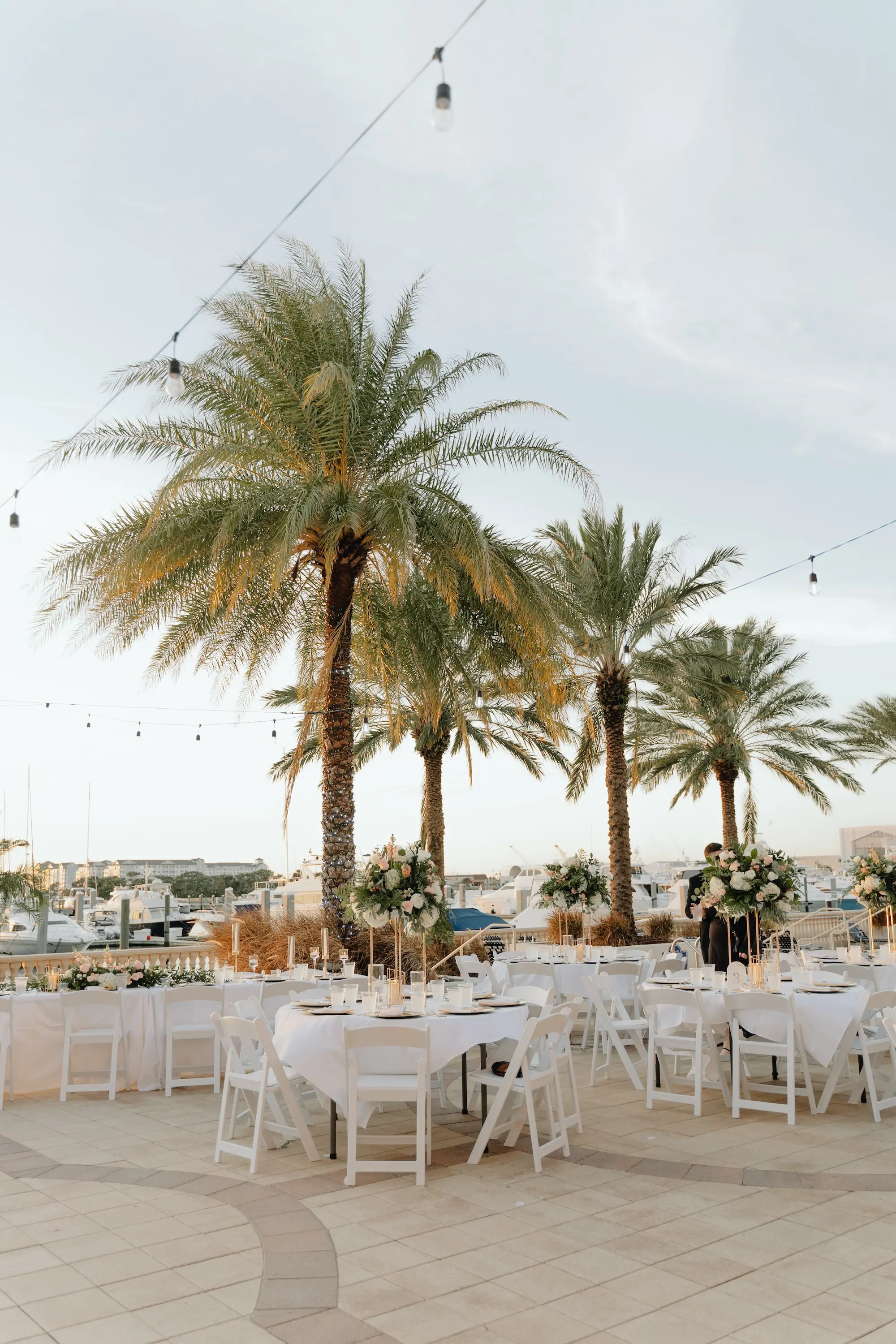 29Romantic Rose Gold and Champagne Wedding Ideas - “Best Of” 2025: Wedding Receptions Part 2 Rose Gold and Champagne Outdoor Waterfront Wedding Reception Decor Inspiration | White Chairs with White Linens and Sting Bistro Lights Decor Ideas | Tampa Bay Florida Waterfront Wedding Venue Westshore Yacht Club