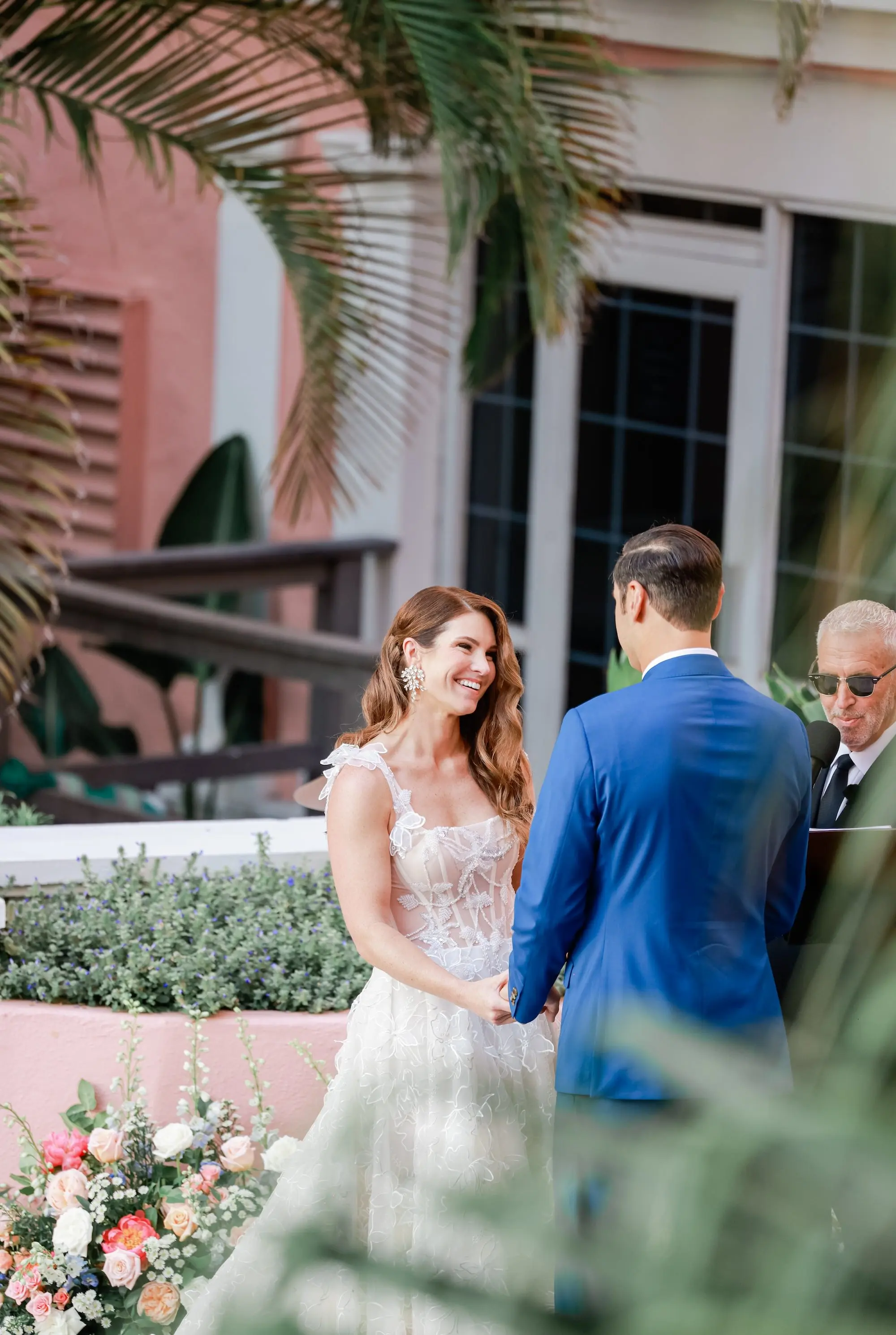 Bride and Groom Wedding Ceremony Vow Exchange Wedding | Pink, White, Coral Roses and Baby's Breath Flower Arrangement Wedding Ceremony Aisle Decor Ideas | Gold Chiavari Chair Rentals by Tampa Bay Kate Ryan Event Rentals | Outdoor Beachfront Resort Wedding Ceremony Venue | St Pete Beach Wedding Venue Don CeSar | Tampa Bay Planner Blue Skies Weddings and Events | St Pete Photographer Lifelong Photography Studio