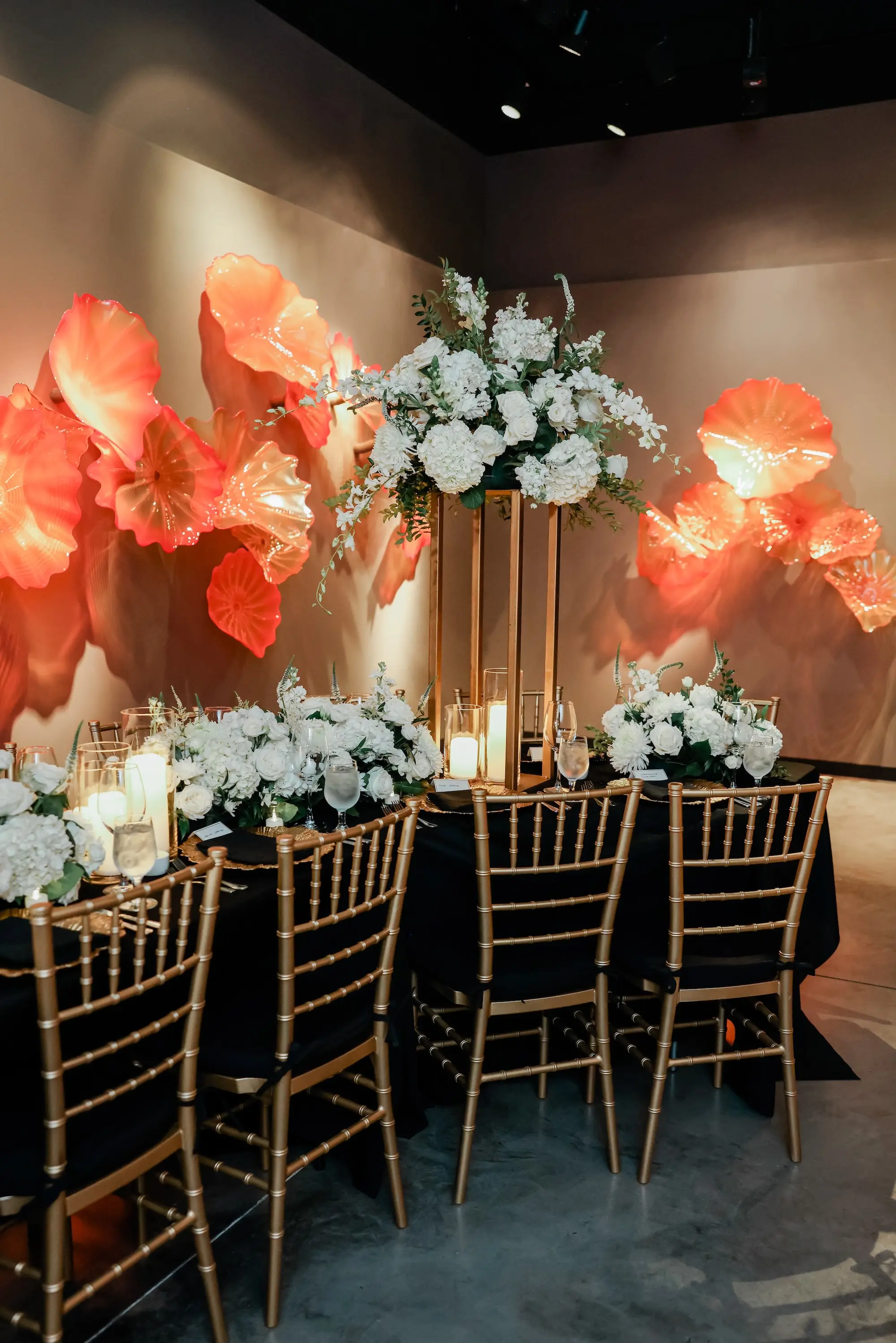31Classic White Chic St Pete Museum Wedding Inspiration Venue Chihuly Collection - “Best Of” 2025: Wedding Receptions Part 2 Luxurious Ballroom Wedding Reception | Gold Chiavari Chairs | Tall Gold Centerpieces with White Hydrangeas, Roses and Orchid Flower Arrangement Ideas | Venue The Chihuly Collection at the Morean Arts Center | Tampa Bay Planner Coastal Coordinating