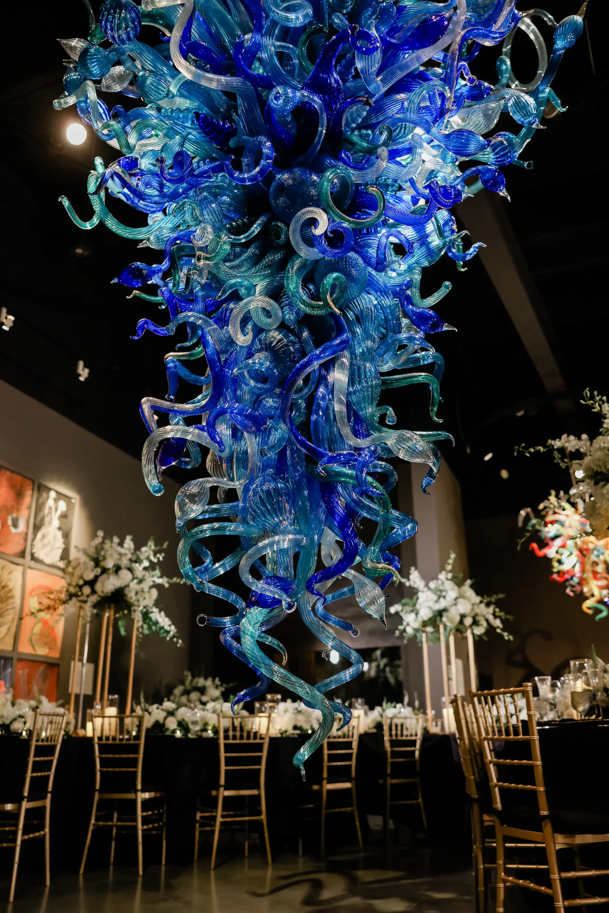 32Classic White Chic St Pete Museum Wedding Inspiration Venue Chihuly Collection - “Best Of” 2025: Wedding Receptions Part 2 Luxurious Ballroom Wedding Reception | Gold Chiavari Chairs | Tall Gold Centerpieces with White Hydrangeas, Roses and Orchid Flower Arrangement Ideas | Venue The Chihuly Collection at the Morean Arts Center | Tampa Bay Planner Coastal Coordinating