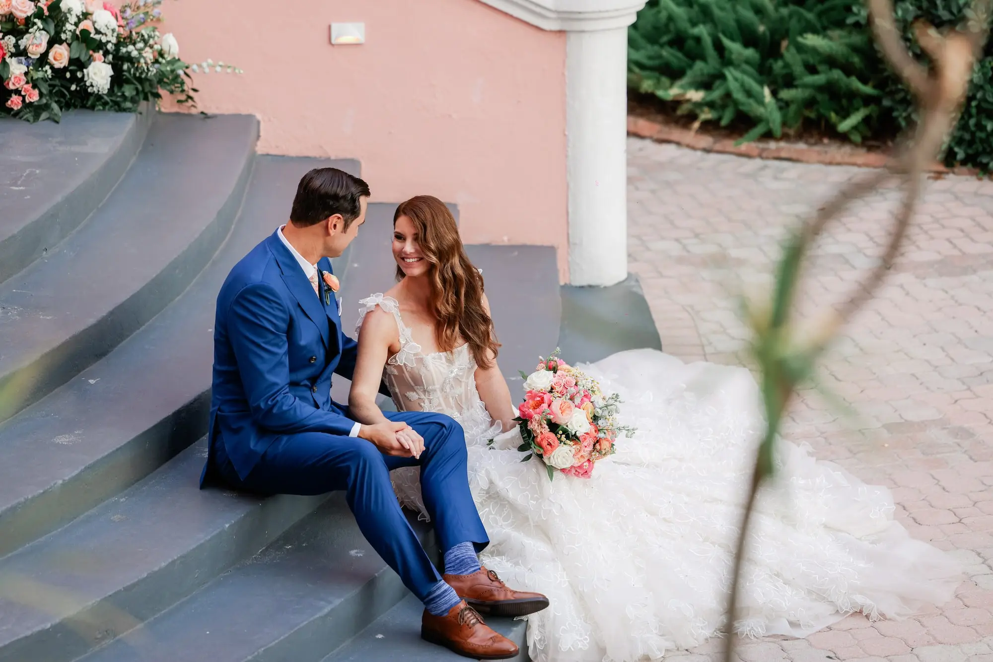 Bride and Groom Wedding Portrait | Lace and Tulle Galia Lahav Wedding Gown with Fitted Bodice and Full Layered, Ruffled Skirt and Train Ideas | Blue Groom Suit Inspiration | Soft, Romantic Beach Curls Bridal Hair Ideas | White, Pink, Coral Roses and Peonies Bridal Bouquet Inspiration | Ybor Hair and Makeup Artist Adore Bridal Hair and Makeup | Venue St. Pete Beach Don CeSar | Tampa Bay Planner Blue Skies Weddings and Events | St Pete Photographer Lifelong Photography Studio