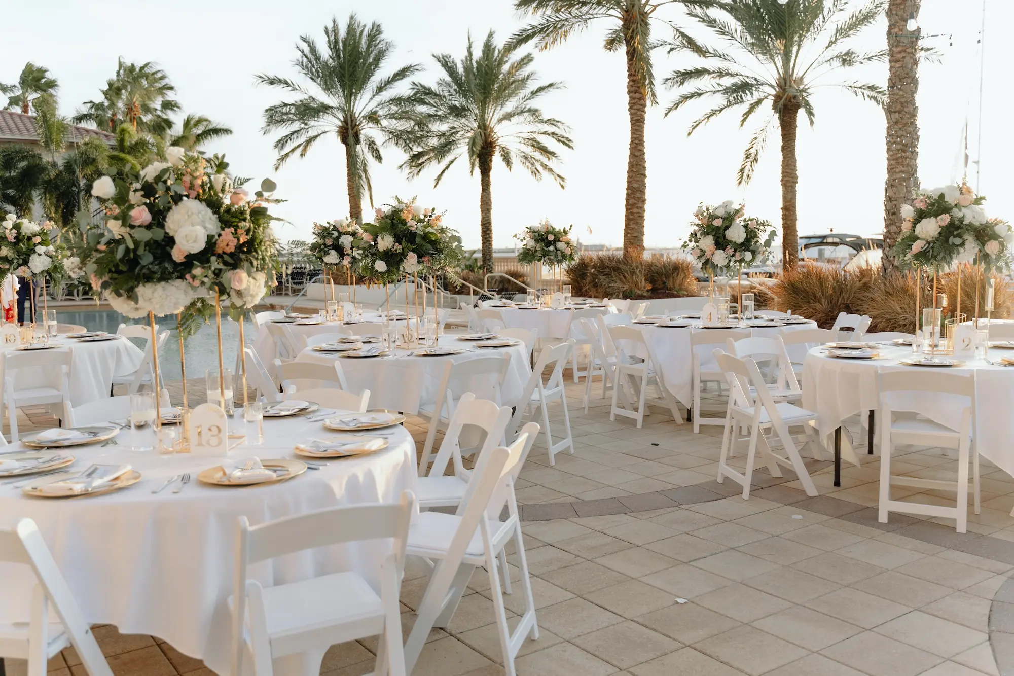 35Romantic Rose Gold and Champagne Wedding Ideas - “Best Of” 2025: Wedding Receptions Part 2 Rose Gold and Champagne Outdoor Waterfront Wedding Reception Decor Inspiration | White Chairs with White Linens and Sting Bistro Lights Decor Ideas | Tampa Bay Florida Waterfront Wedding Venue Westshore Yacht Club