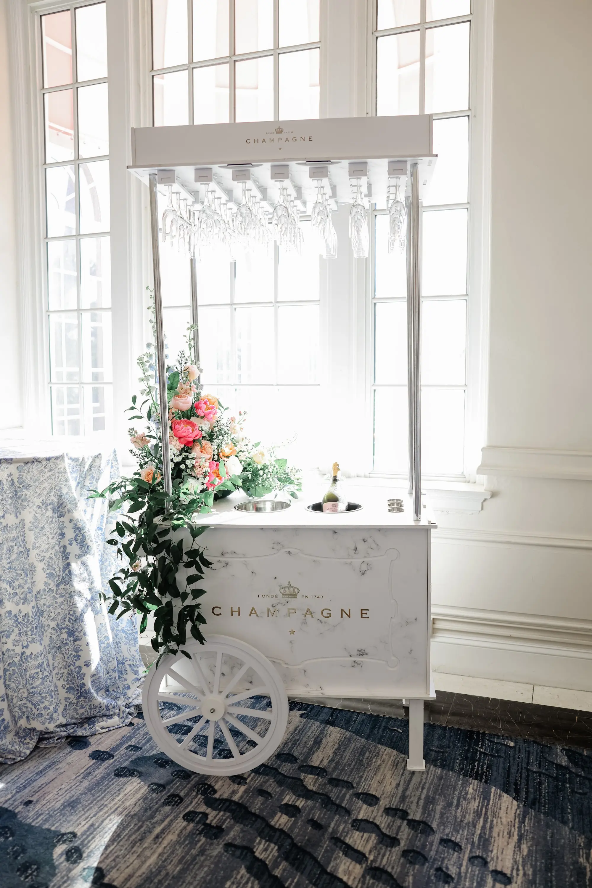 Champagne Cart Wedding Reception Decor Inspiration | Pink, Coral, White Roses with Eucalyptus and Baby's Breath Flower Arrangements Reception Decor Ideas | Tampa Bay Kate Ryan Event Rentals | Planner Blue Skies Weddings and Events
