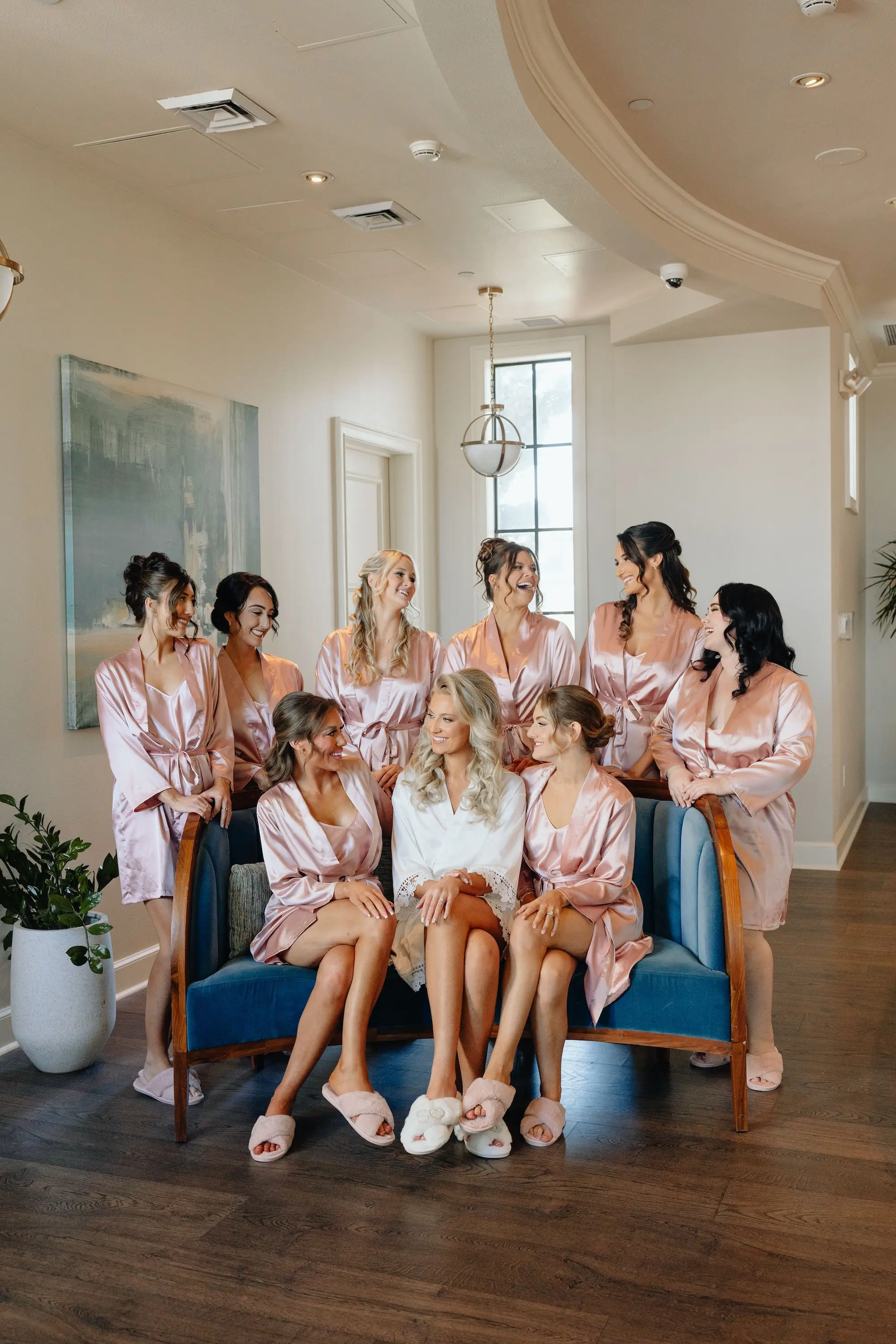 Bride and Bridesmaids Getting Ready Wedding Portrait in Rose Gold Robes | Half Up Half Down Face Framing Curls Wedding Hair Ideas | Old Hollywood Glam Makeup Inspiration | Ybor Hair and Makeup Artist Adore Bridal Hair and Makeup | Florida Photographer and Videographer J&S Media Wedding Films & Photo