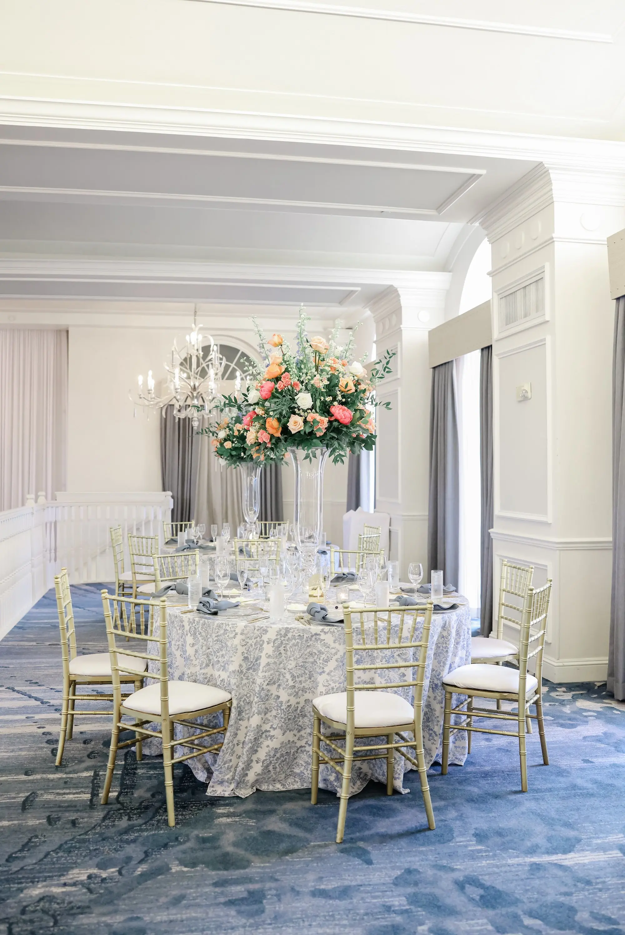 Luxurious Ballroom Wedding Reception | Classic Chiavari Chair Rentals by Tampa Bay Kate Ryan Event Rentals | Tall Acrylic Centerpieces with White Peonies, Roses, and Wisteria Flower Arrangement Ideas | White and Blue Floral Linens with Light Blue Napkins Wedding Reception Decor Inspiration | St Pete Beach Wedding Venue Don CeSar | Tampa Bay Planner Blue Skies Weddings and Events