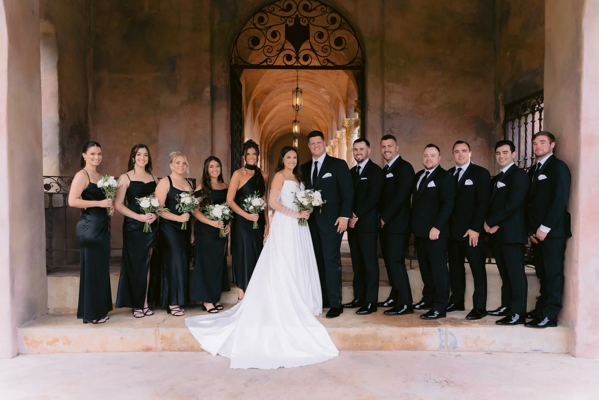 European Inspired Bridal Party Wedding Attire Inspiration | Black Mismatched Satin Bridesmaids Dresses | Groomsmen in Black Tuxedos