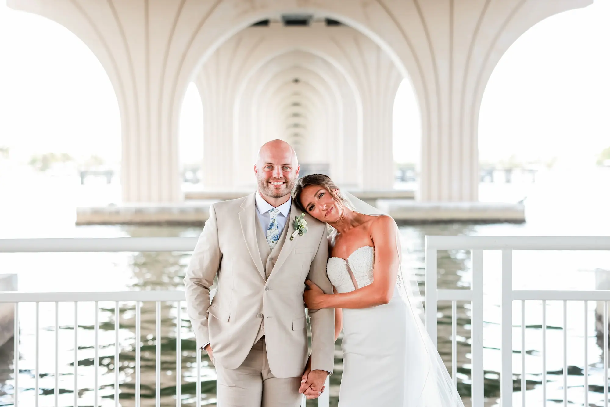 Bride and Groom Waterfront Wedding Portrait | Tan Groom's Suit with Floral Tie Inspiration | Fit-And-Flare Silhouette Strapless Wedding Gown Ideas | St Pete Photographer Lifelong Photography Studio