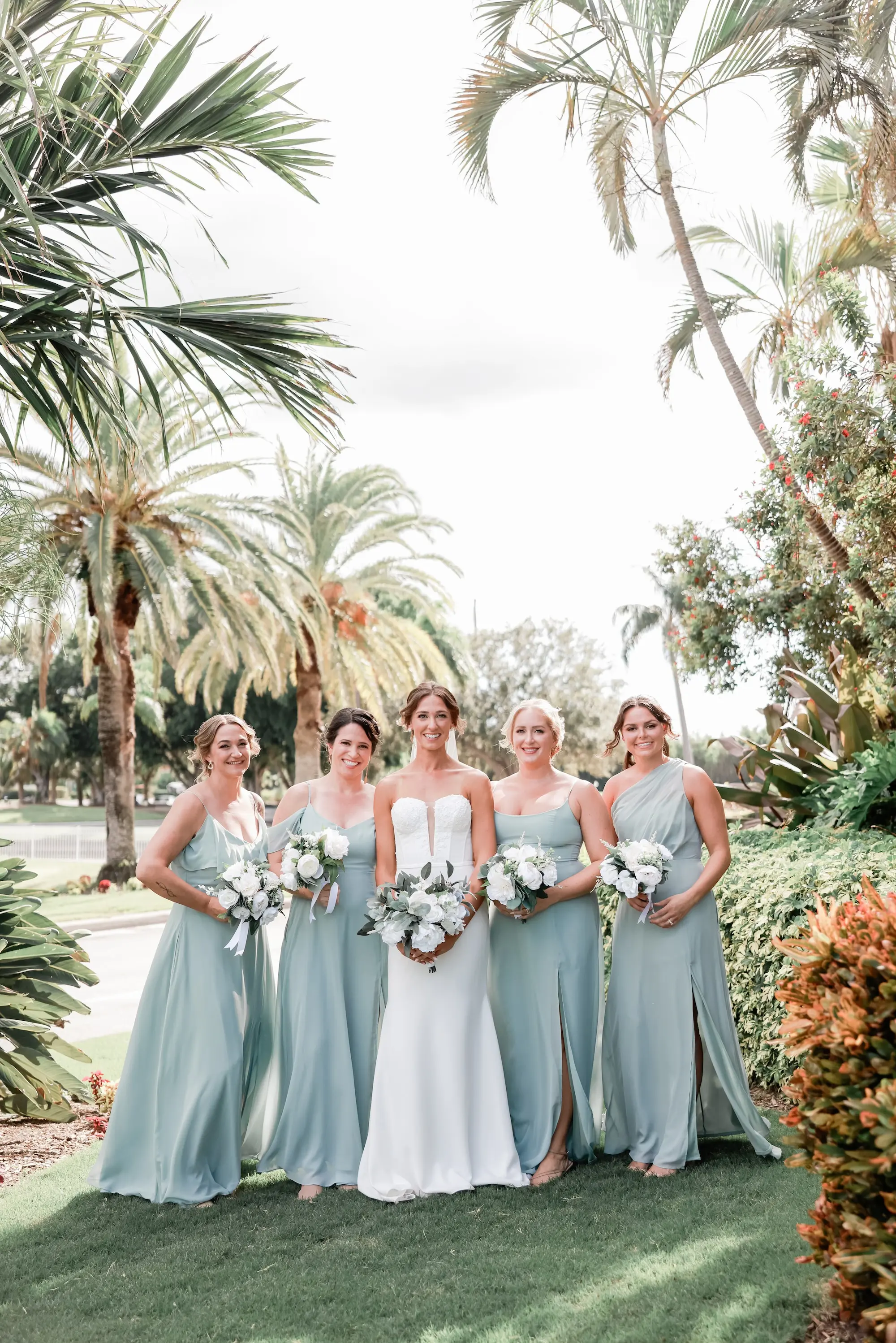 Bride and Bridesmaids Outdoor Wedding Portrait | Different Style Sage Chiffon Bridesmaid Dresses Inspiration | Fit-And-Flare Silhouette Strapless Wedding Gown Ideas | Classic White Roses and Greenery Bridal Bouquet Inspiration | St Pete Photographer Lifelong Photography Studio