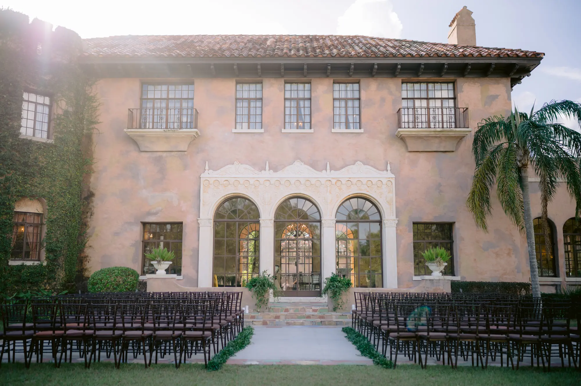 European Inspired Wedding Ceremony Decor Ideas | Black Chiavari Chairs | Greenery Aisle Display | Tampa Bay Event Venue The Howey Mansion