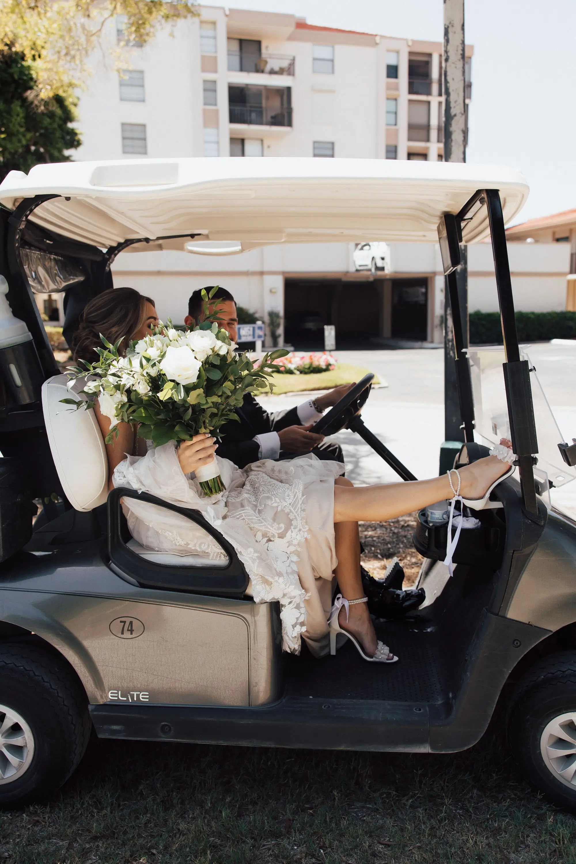 Bride and Groom in Golf Cart Wedding Portrait | Classic White Roses with Greenery Bridal Bouquet Ideas