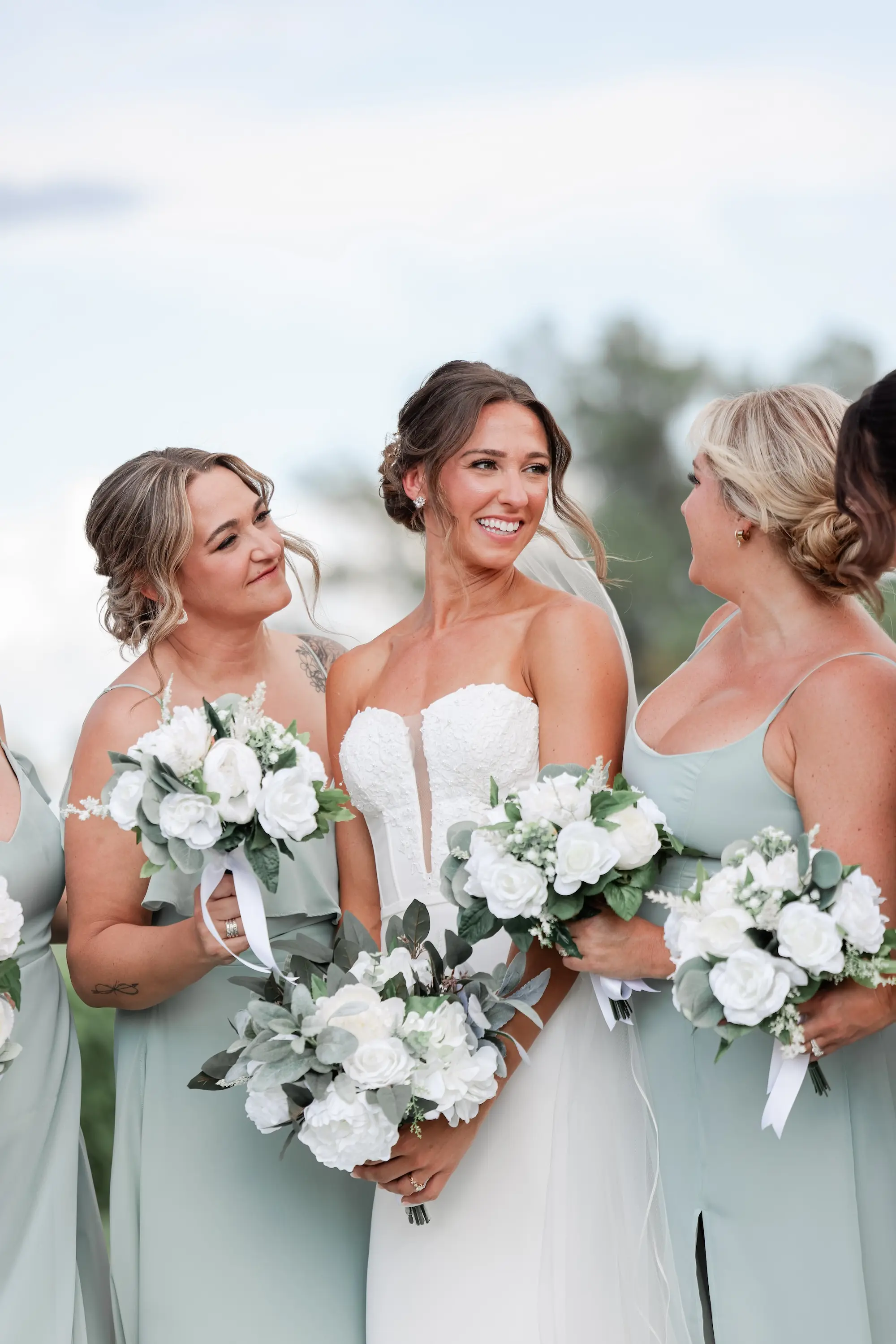 Bride and Bridesmaids Outdoor Wedding Portrait | Different Style Sage Chiffon Bridesmaid Dresses Inspiration | Fit-And-Flare Silhouette Strapless Wedding Gown Ideas | Classic White Roses and Greenery Bridal Bouquet Inspiration | St Pete Photographer Lifelong Photography Studio