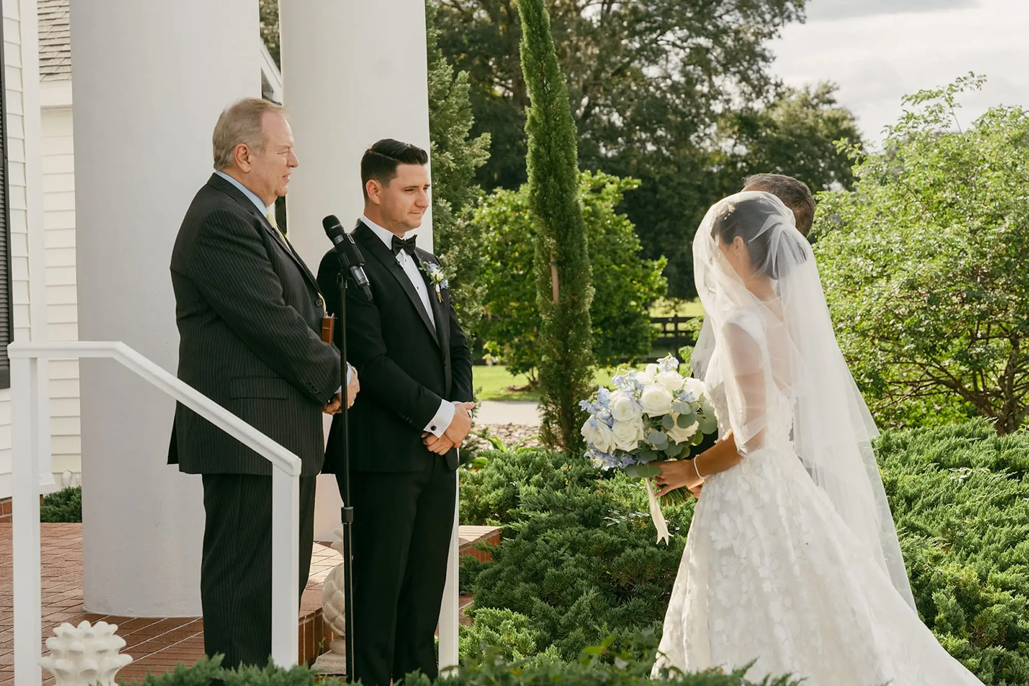 Father Walking Bride Down Wedding Ceremony Aisle | Timeless White Roses with Light Blue Floral Bridal Wedding Bouquet Inspiration | Cathedral Length Veil Ideas