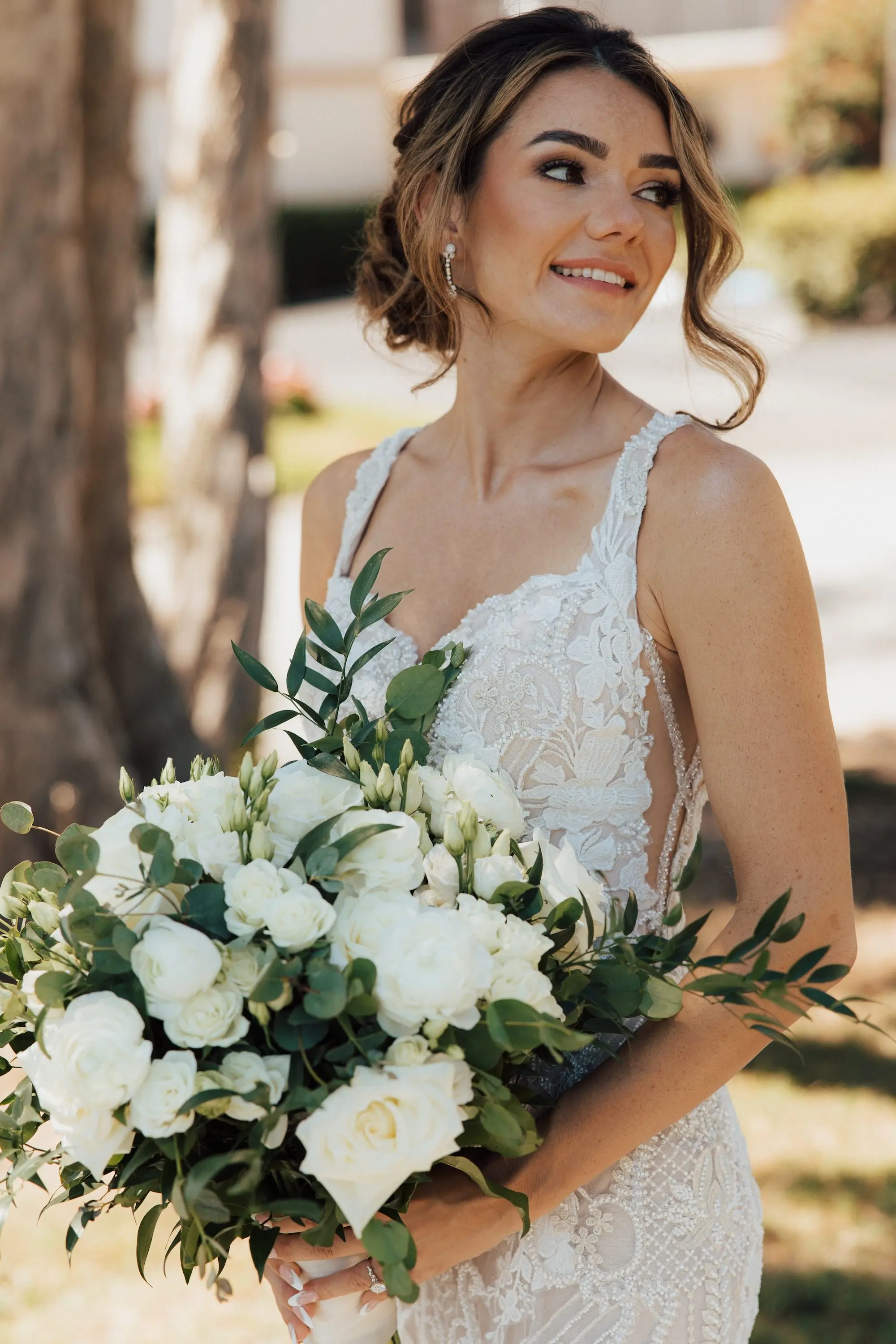 Bride Wedding Portrait | Lace Applique Mermaid Wedding Gown with Long Train Inspiration | Classic Low Bun with Face Framing Soft Curls Bridal Hair Ideas | Traditional White Roses with Greenery Bridal Wedding Bouquet Inspiration