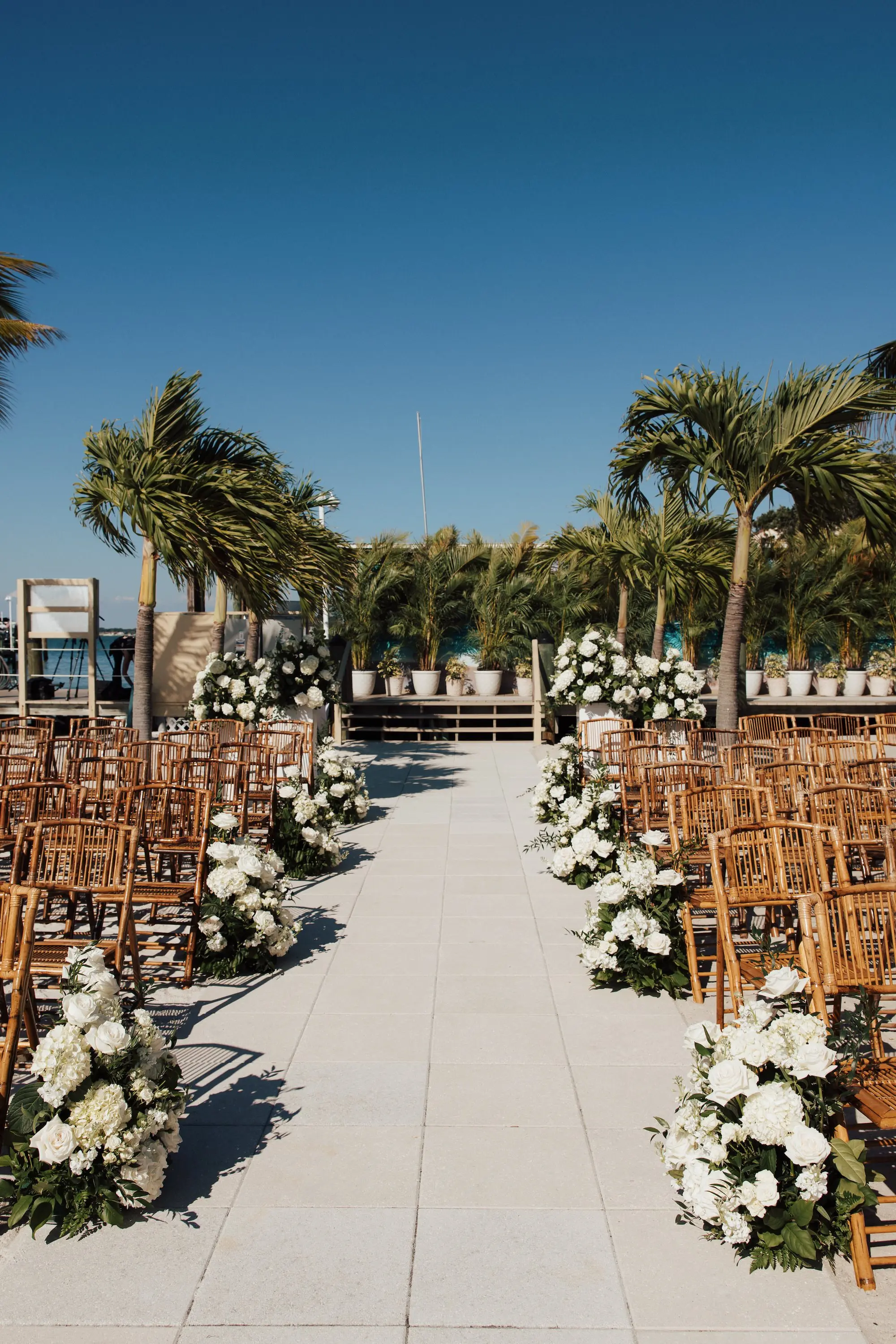 Waterfront Beach Gazebo Outdoor Wedding Ceremony Inspiration | Bamboo Wedding Ceremony Chairs Ideas | White Florals Roses, Hydrangeas Wedding Ceremony Aisle Decor Inspiration | Tampa Bay Event Venue Isla Del Sol Yacht and Country Club