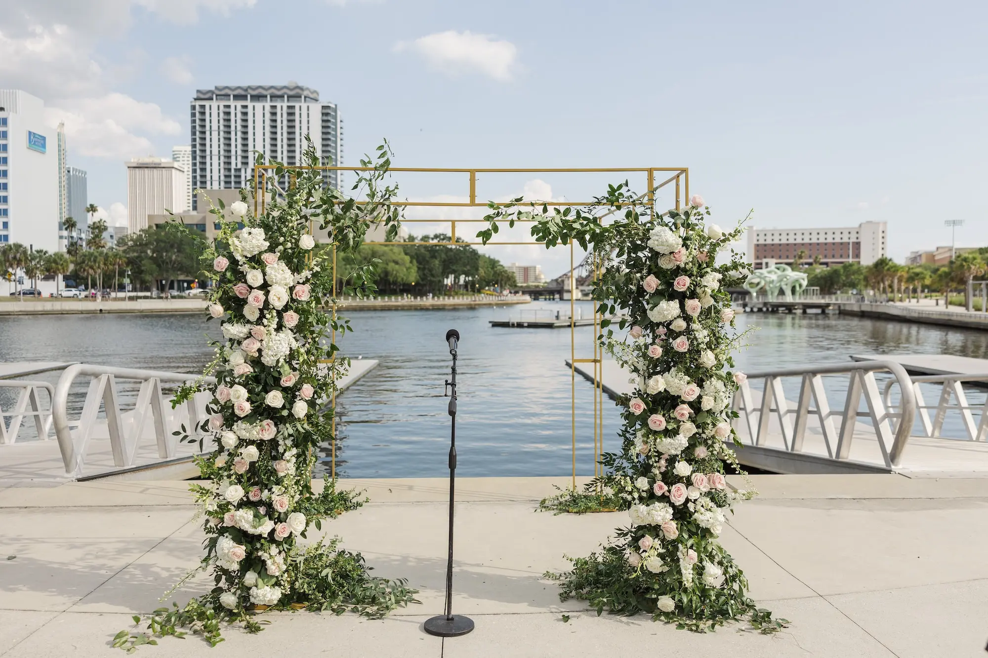 Romantic Outdoor Riverfront Wedding Ceremony Inspiration | Gold Chuppah with Light Pink and White Cascading Florals and Greenery Ideas | Tampa Bay Florist Save The Date Florida