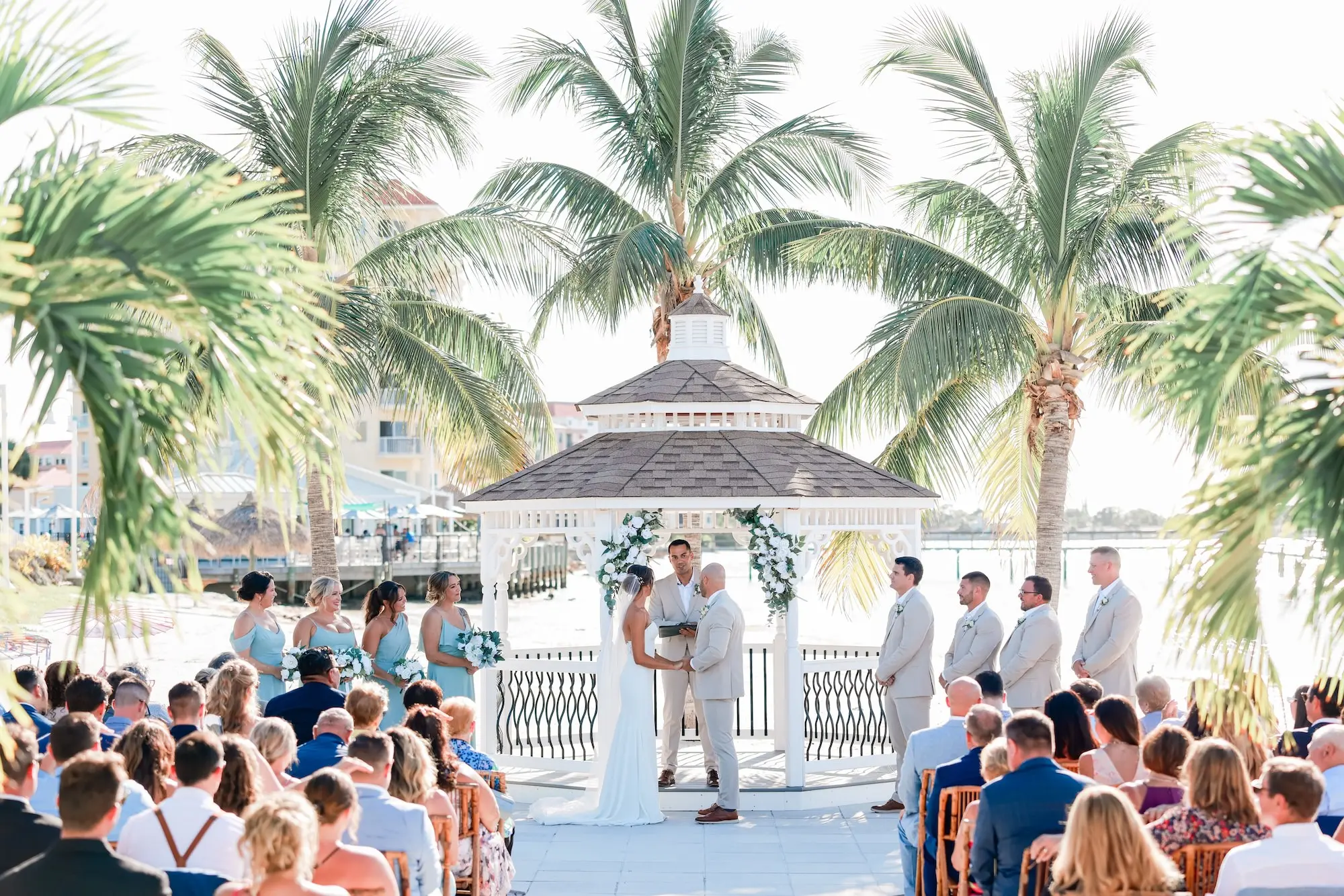 Bride and Groom Outdoor Waterfront Wedding Ceremony Vow Exchange Wedding Portrait | Classic White Roses and Greenery Floral Arrangements Gazebo Decor Ideas | St Pete Event Venue Isla Del Sol Yacht and Country Club | St Pete Photographer Lifelong Photography Studio