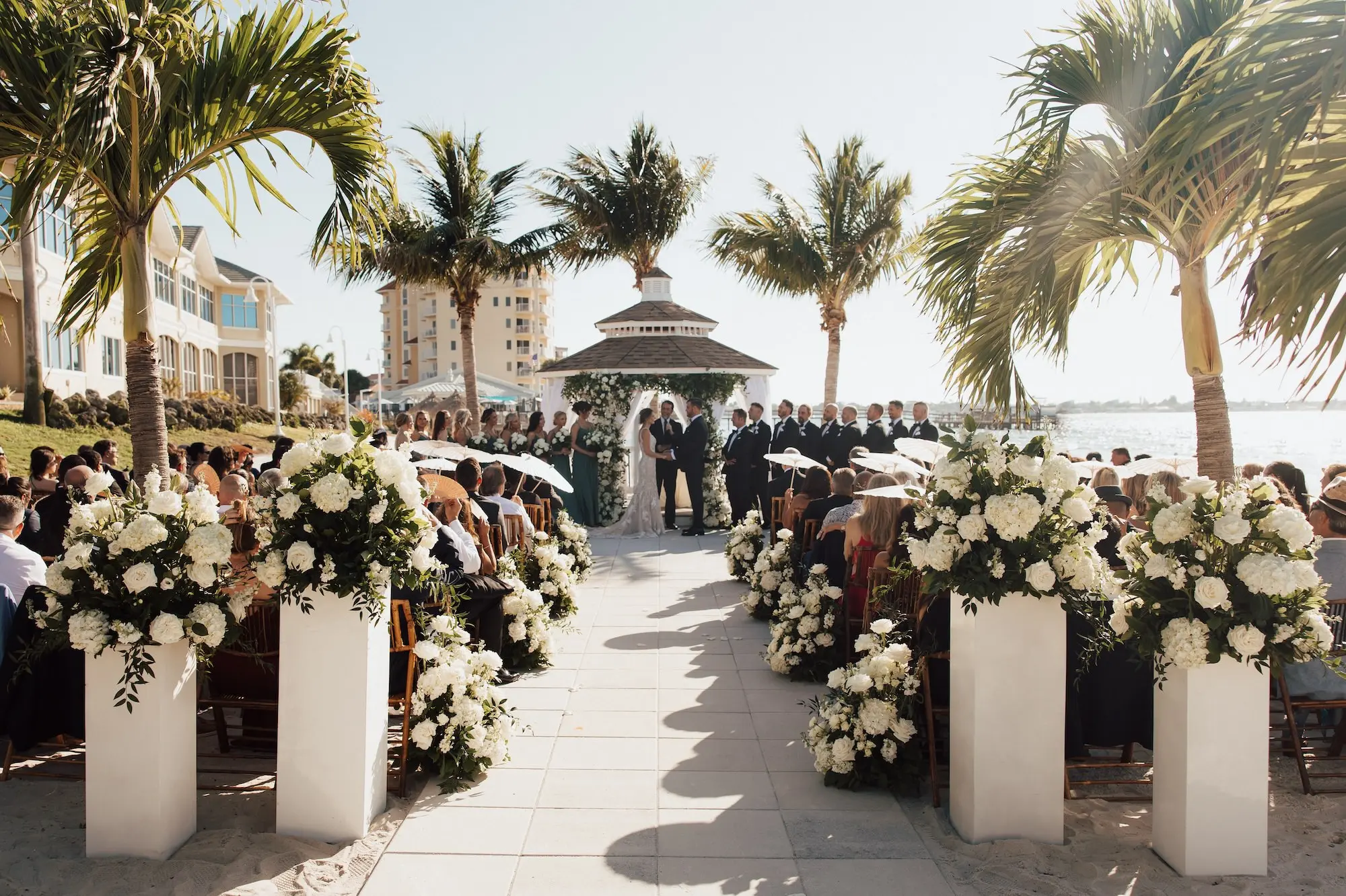 Bride and Groom Outdoor Waterfront Gazebo Wedding Ceremony Vow Exchange Wedding Portrait | Lush White Florals in Greenery Arrangement Ceremony Aisle Decor Ideas | Tampa Bay Event Venue Isla Del Sol Yacht and Country Club